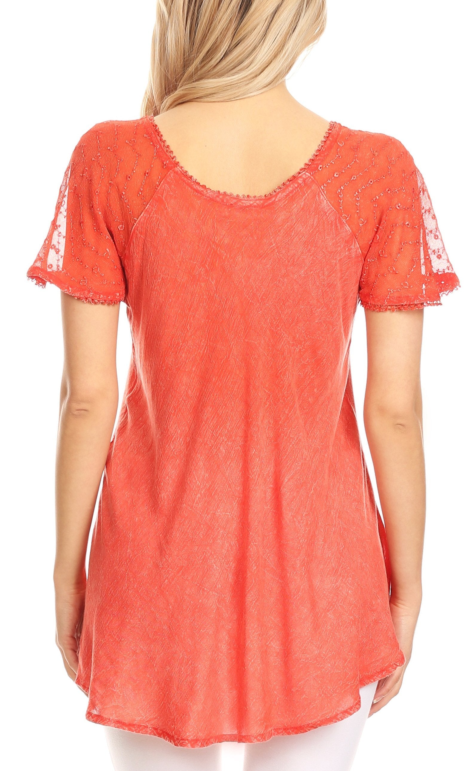 Coral lace-trimmed top worn by a person on a white background