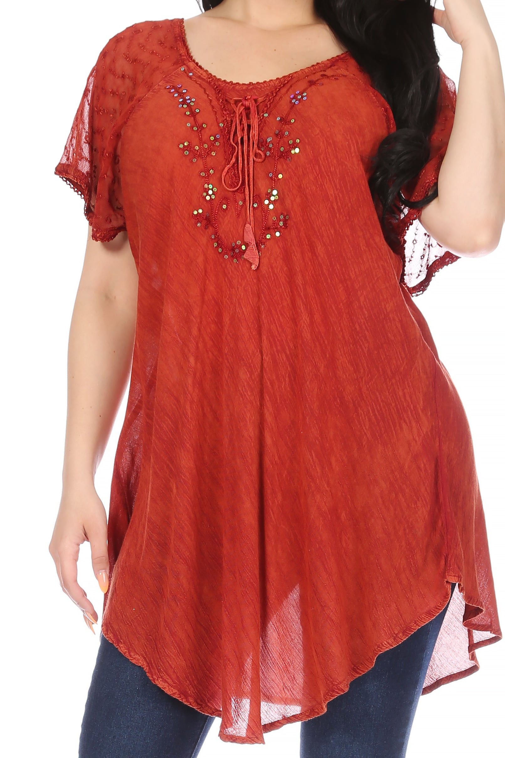 Red embroidered top worn by a model on a white background