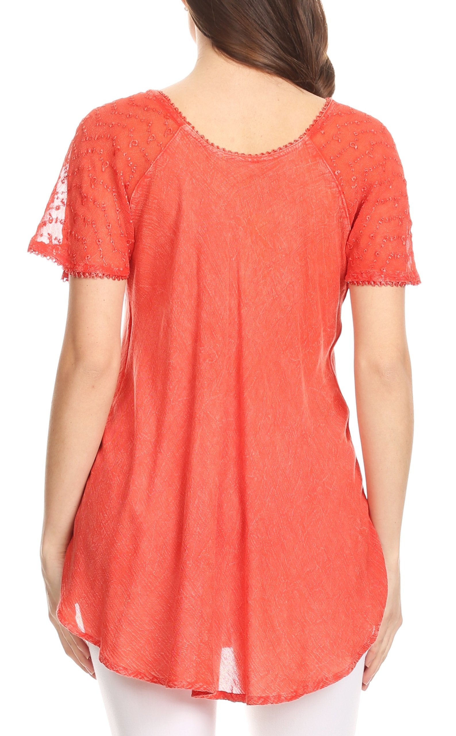 Coral lace-trimmed top worn by a person on a white background