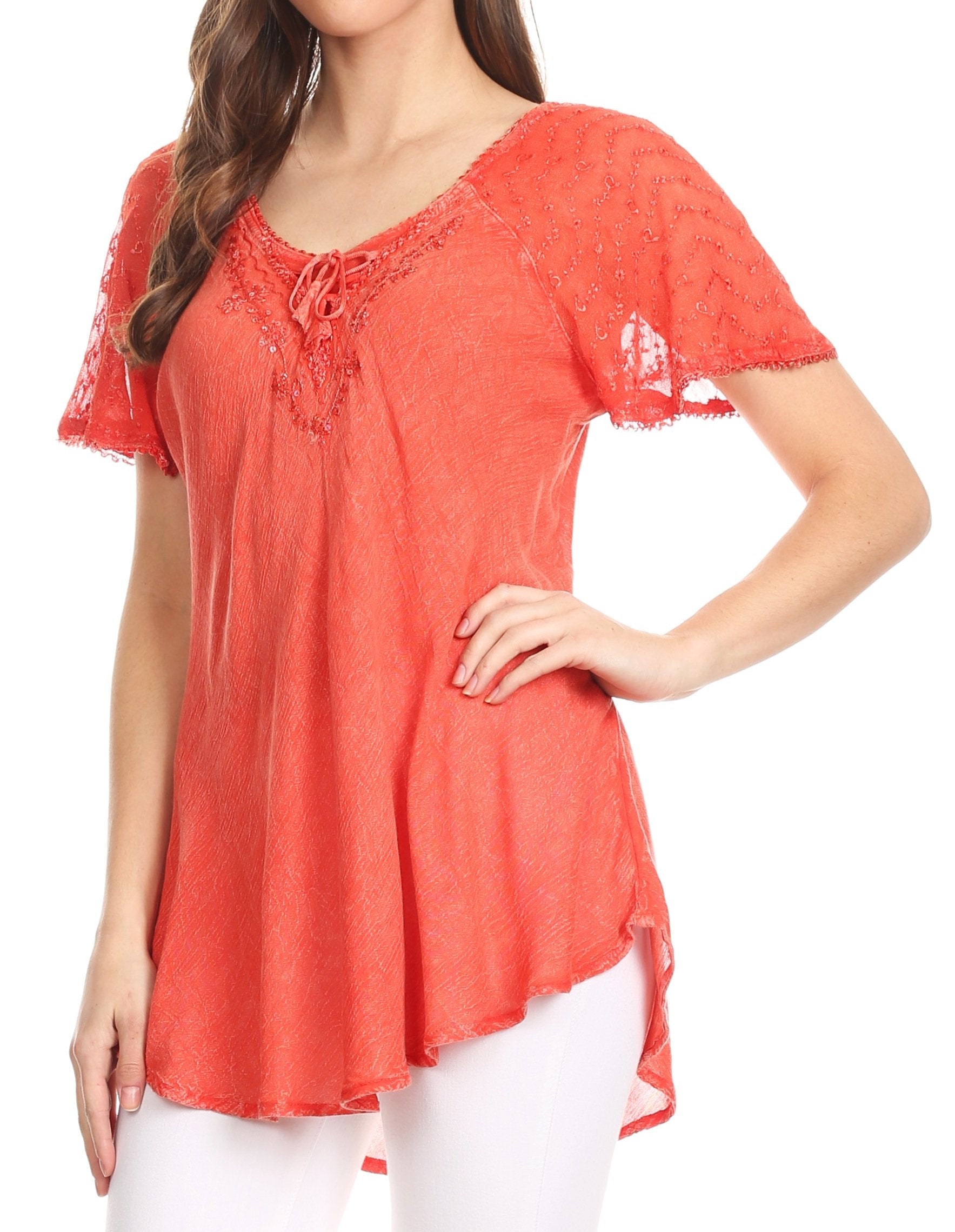 Woman wearing a coral lace top on a white background