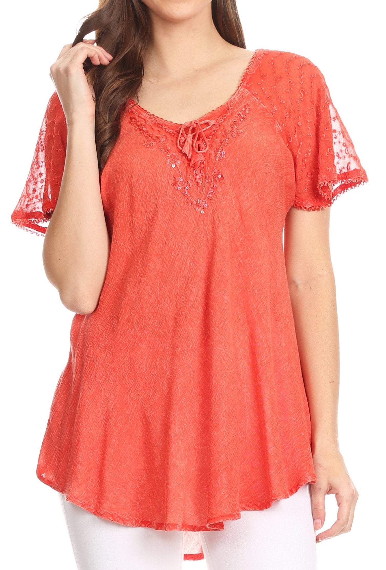 Woman wearing a coral lace top on a white background
