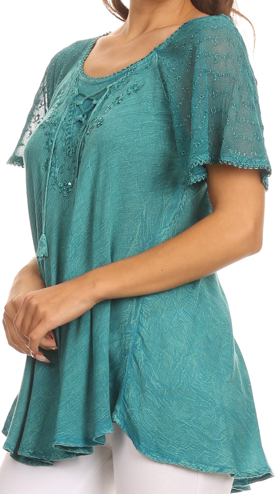 Teal lace top worn by a person on a white background