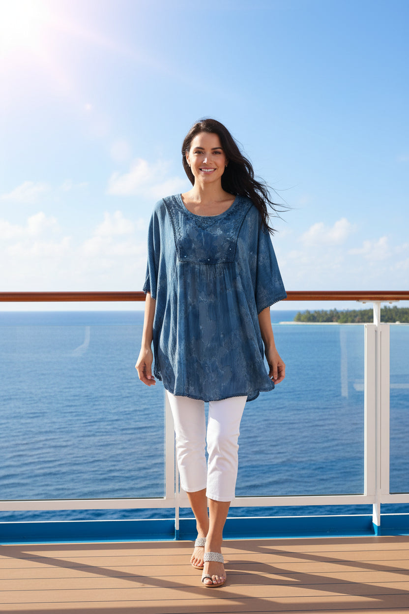 Blue lace top worn by a person on a white background