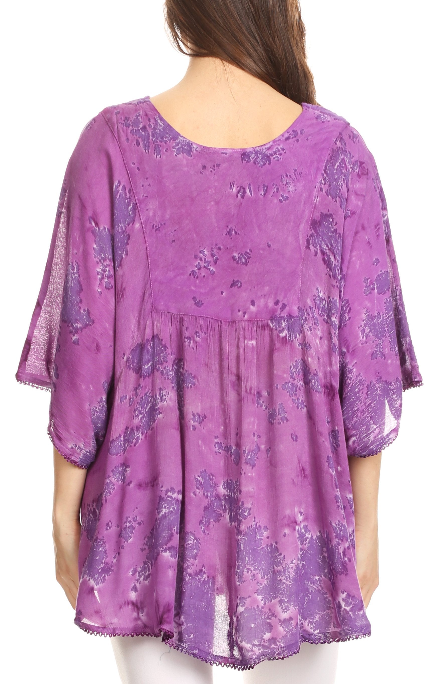 Purple floral blouse worn by a person on a white background