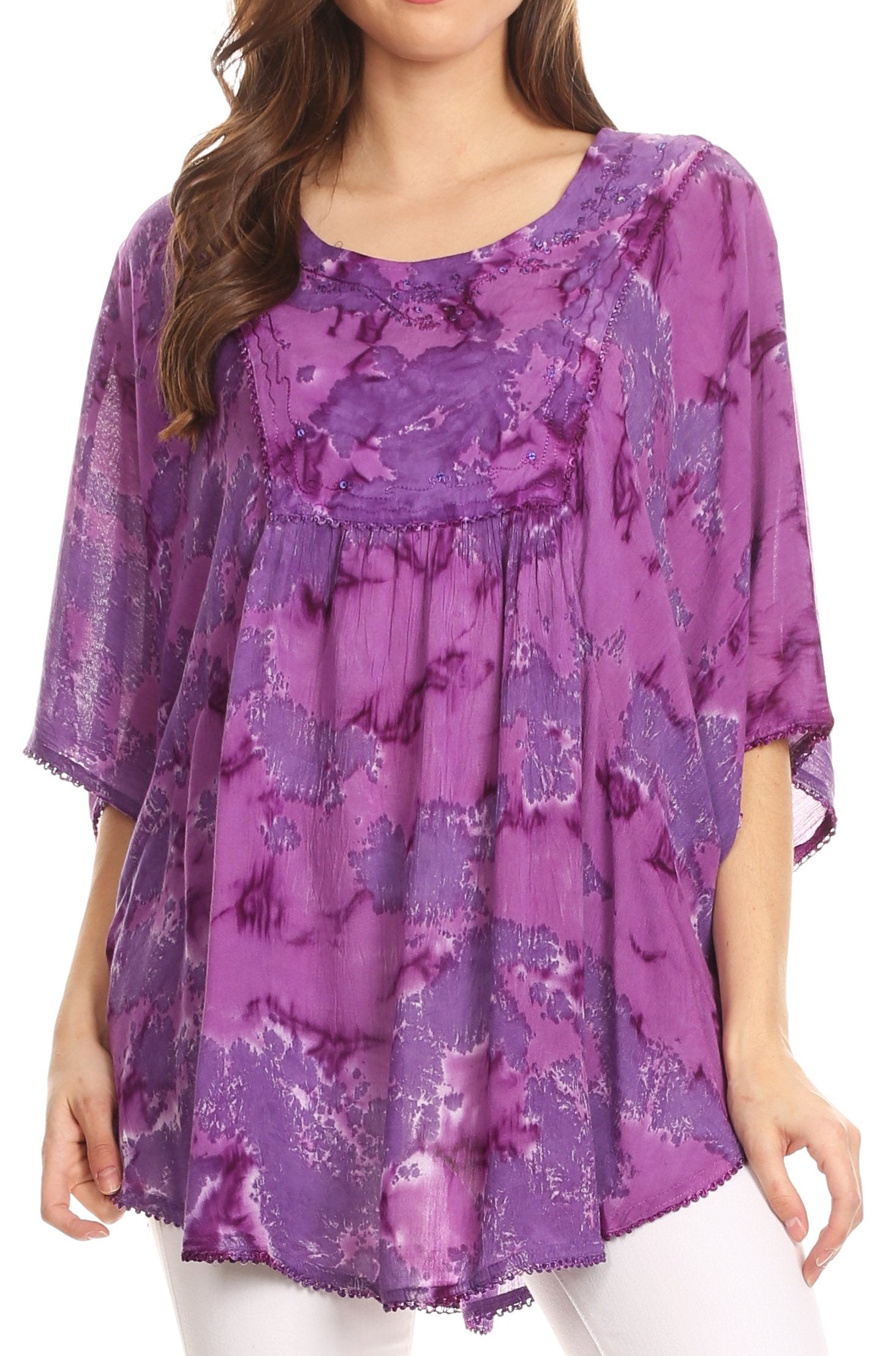 Woman wearing a purple floral patterned top on a white background