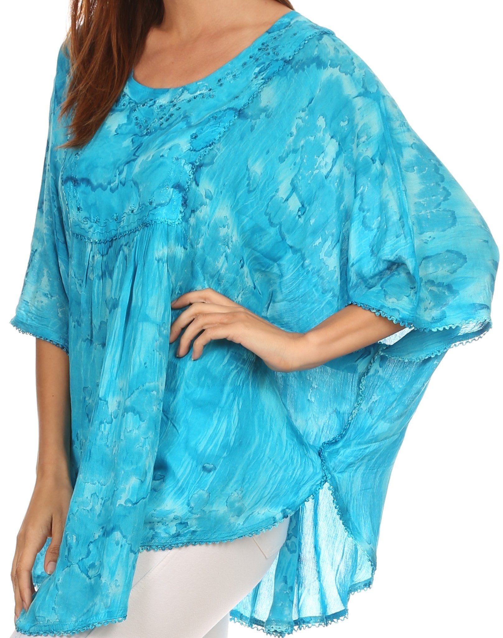 Woman wearing a blue tie-dye top on a white background