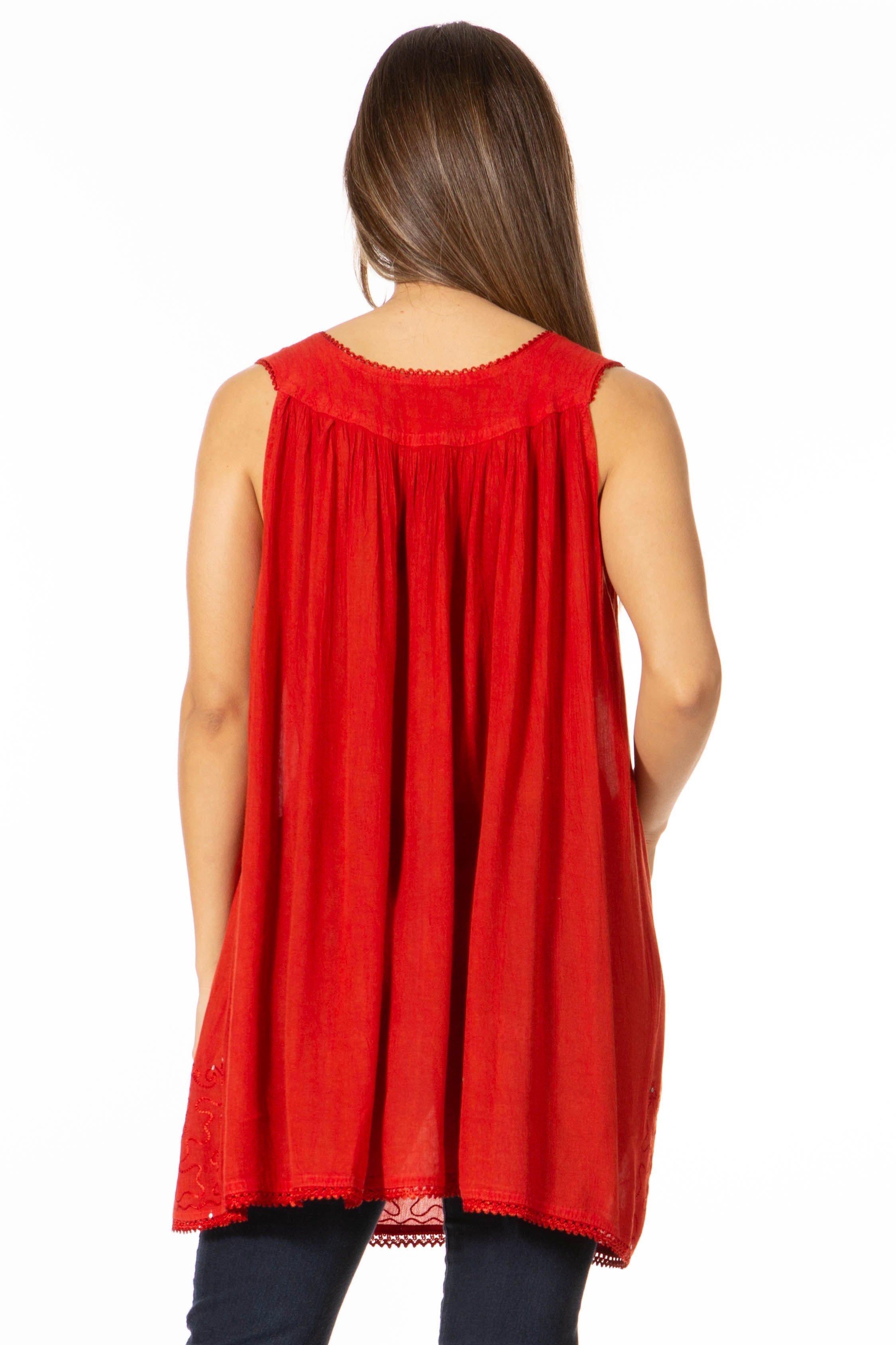 Red sleeveless top worn by a person on a white background