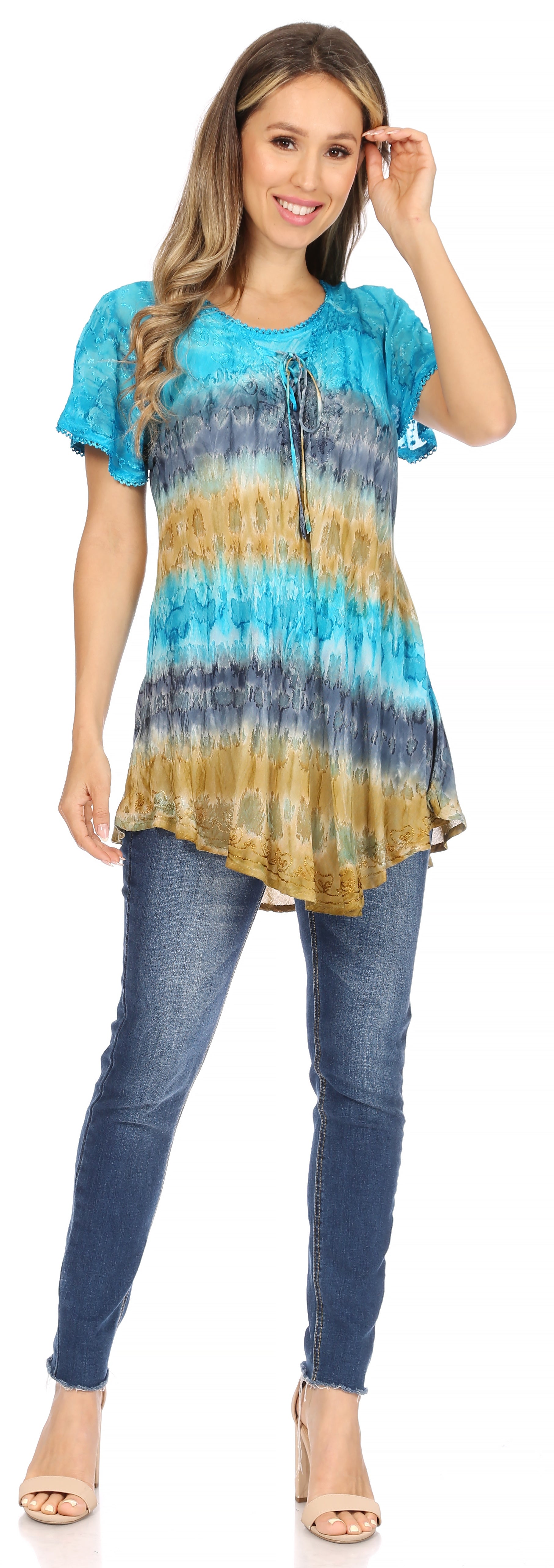 Woman wearing a tie-dye shirt and jeans on a white background