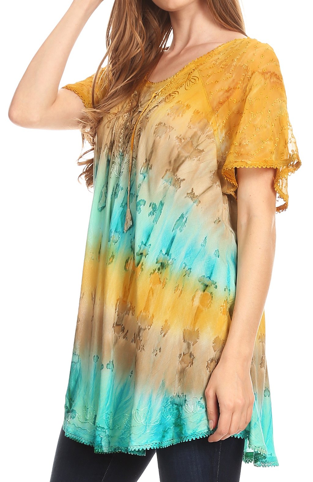 Woman wearing a colorful tie-dye shirt with a gradient from yellow to blue.