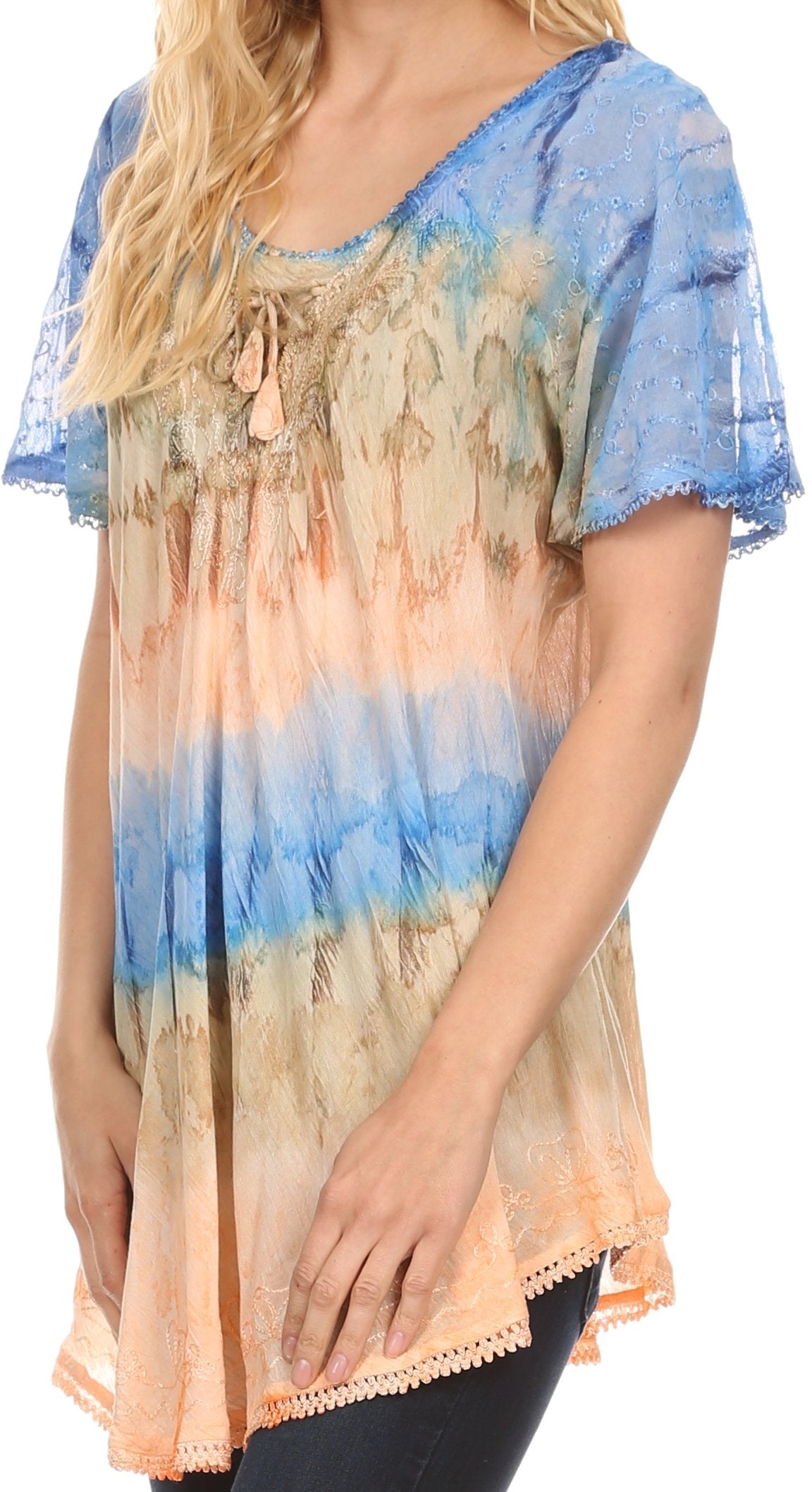 Woman wearing a colorful, patterned blouse with blue and orange gradient.