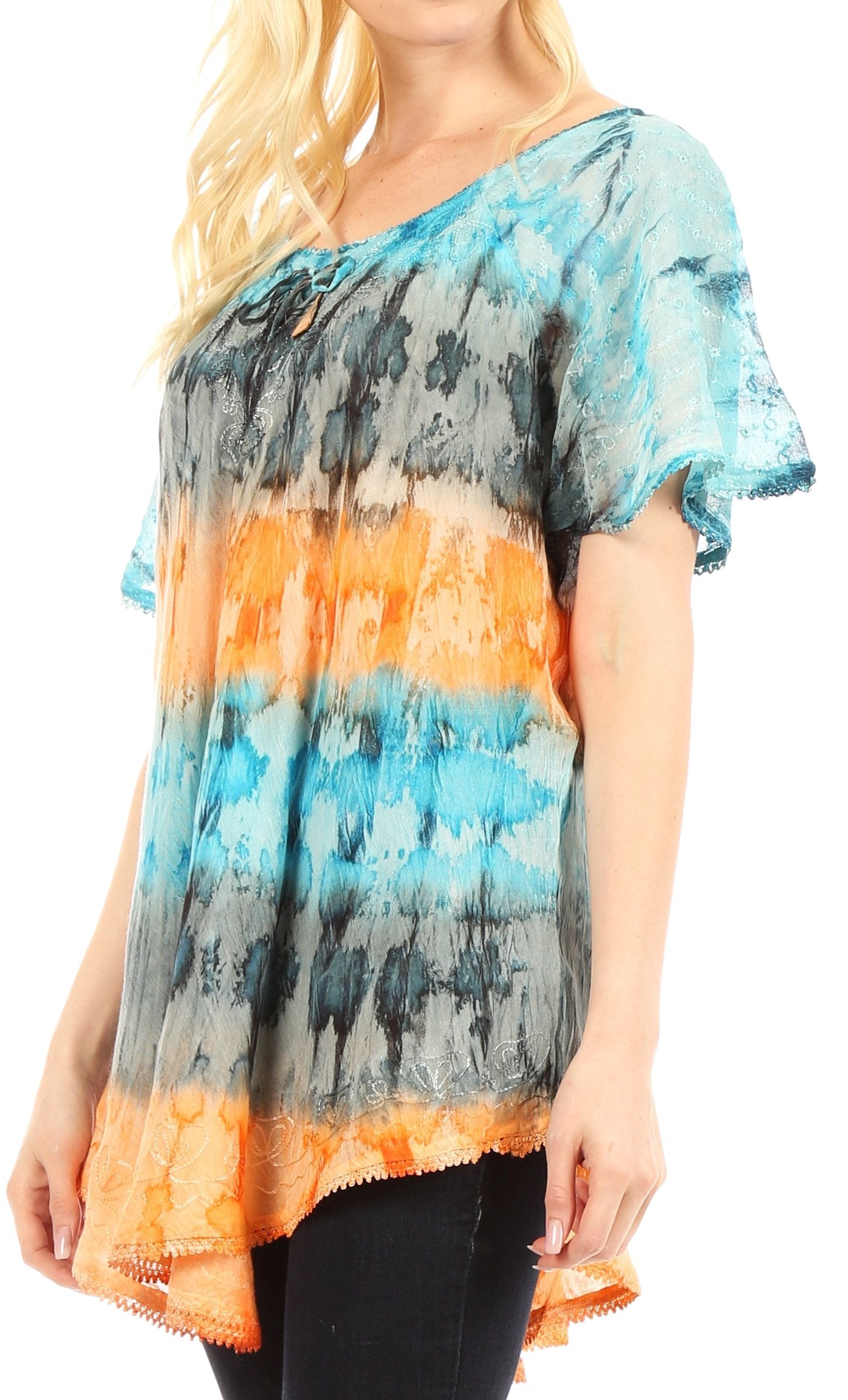 Woman wearing a colorful tie-dye shirt with blue, orange, and gray gradient.
