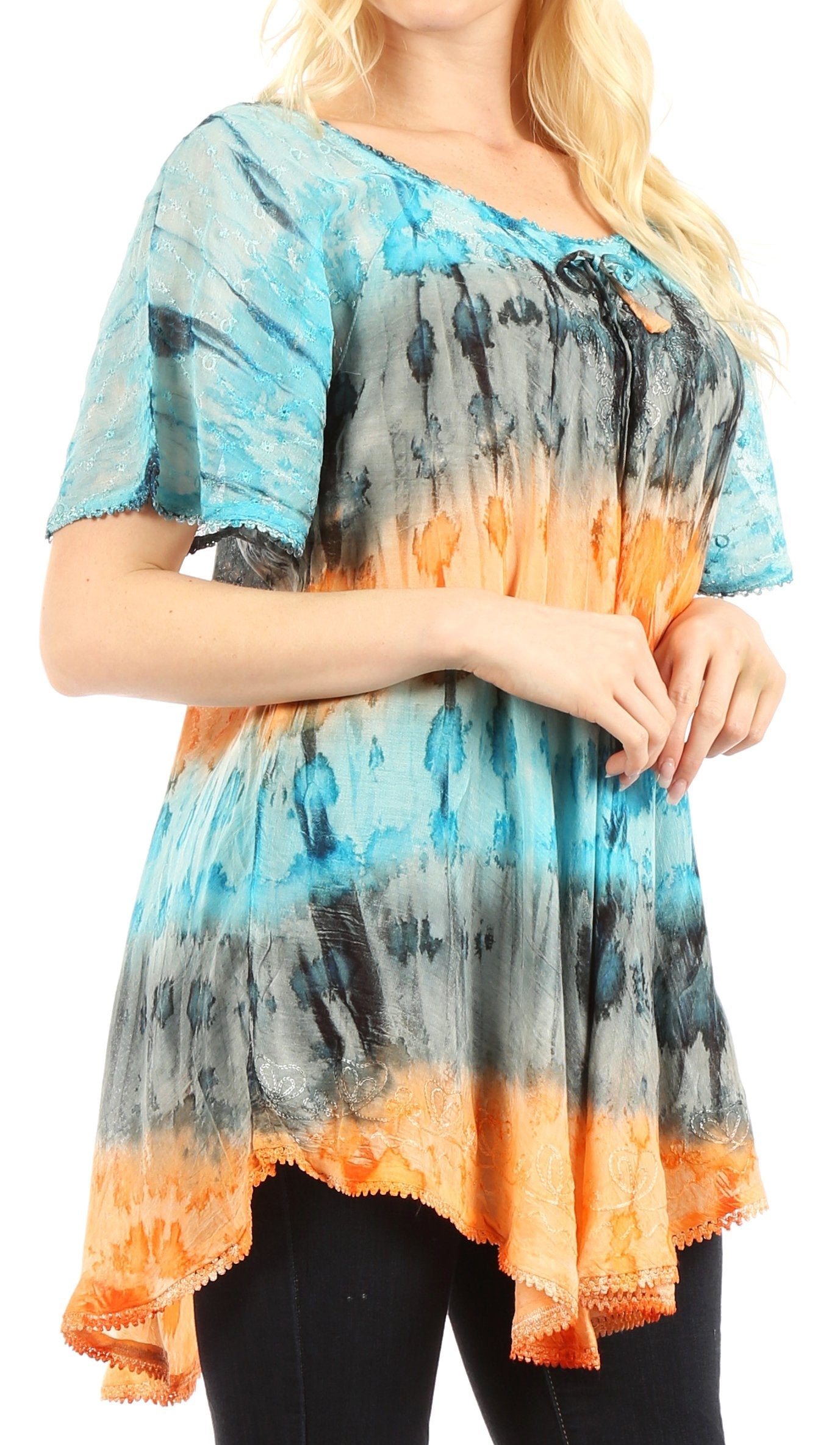 Woman wearing a tie-dye shirt with blue, orange, and black gradient.