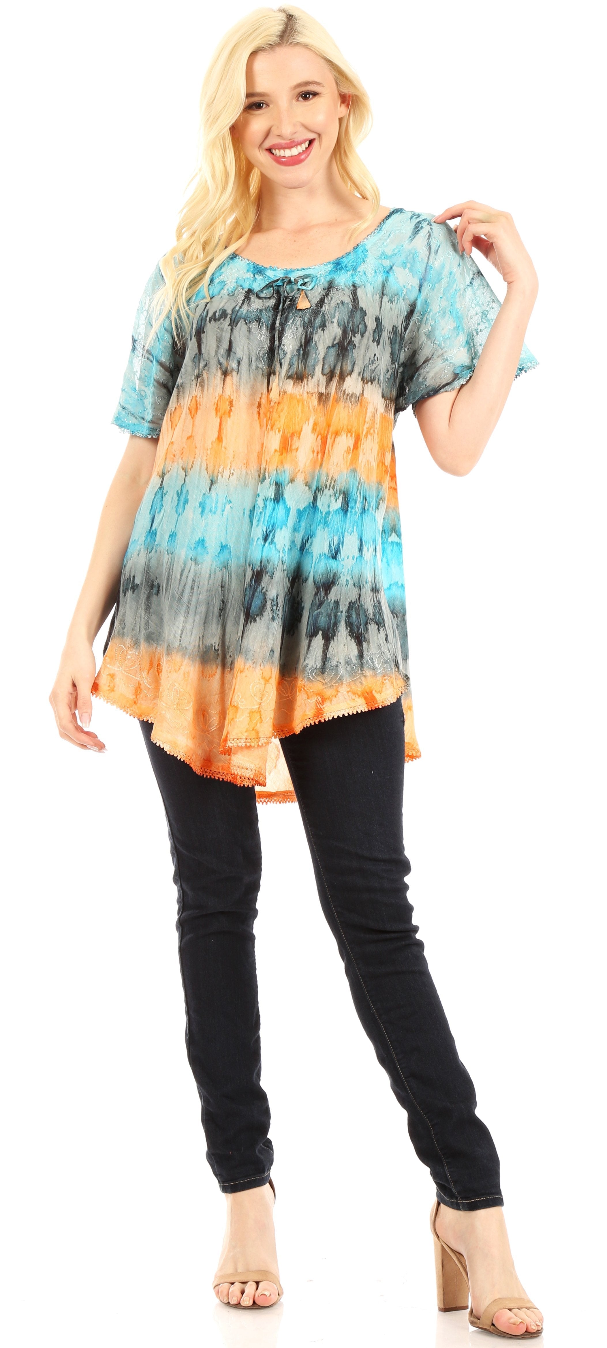 Woman wearing a tie-dye shirt and black pants on a white background
