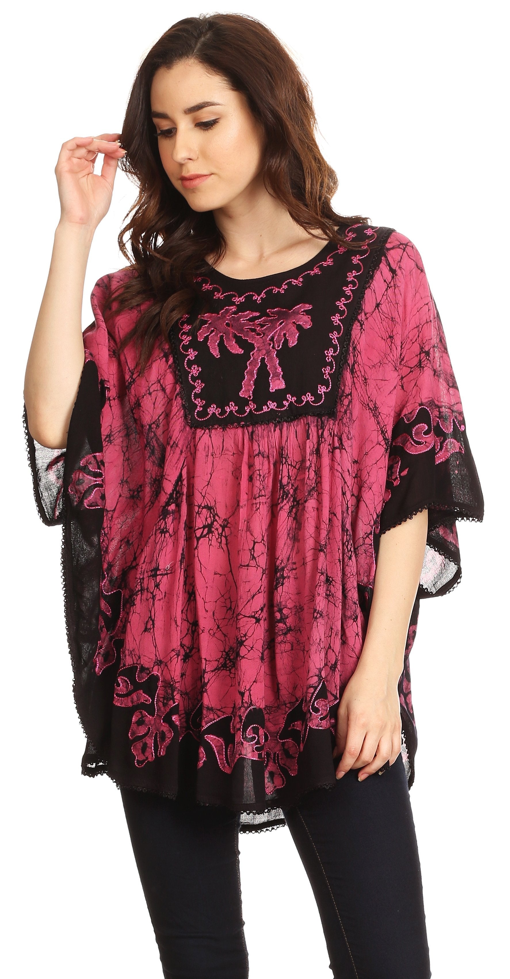 Woman wearing a pink and black patterned top on a white background