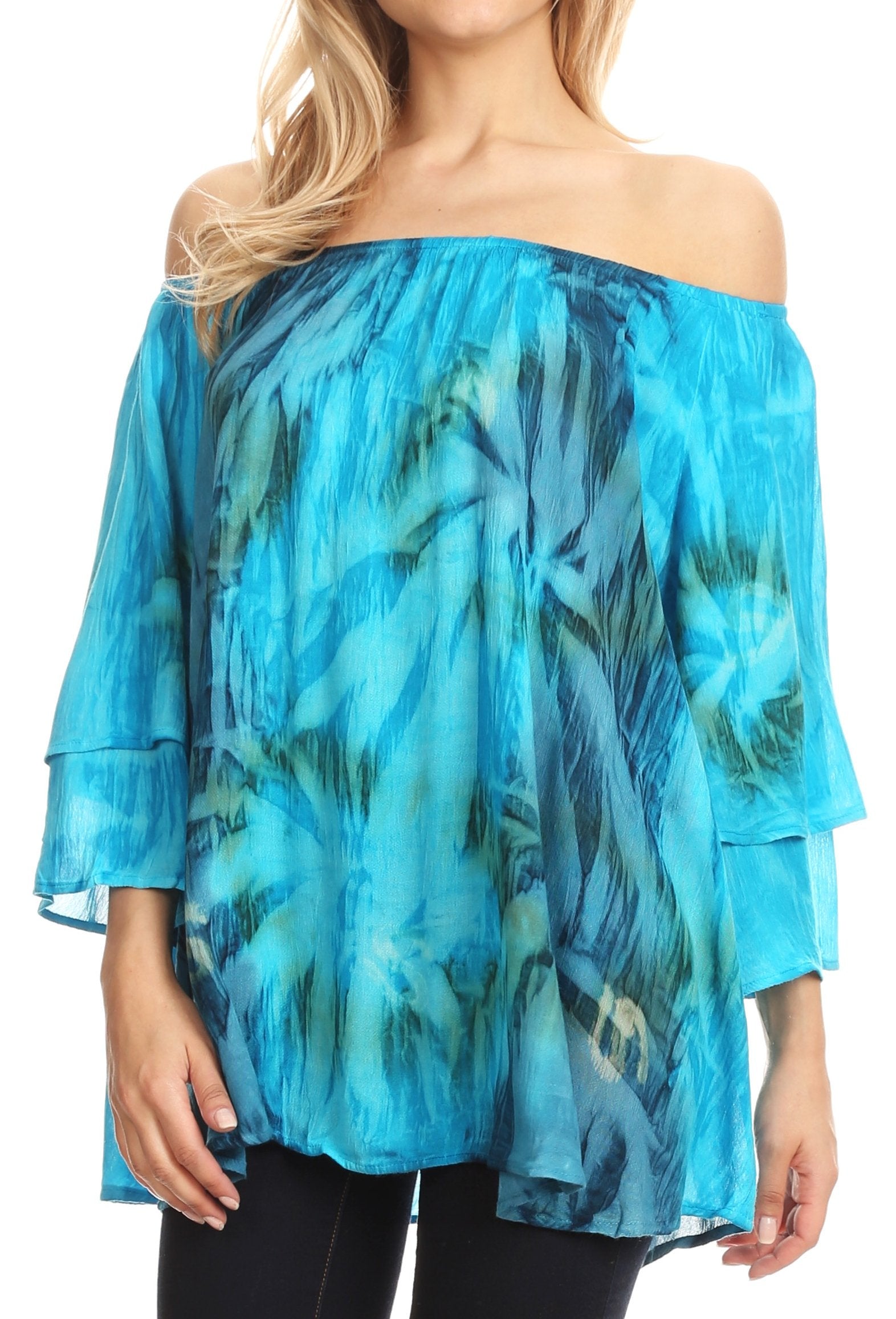 Woman wearing a blue and green patterned off-shoulder top.