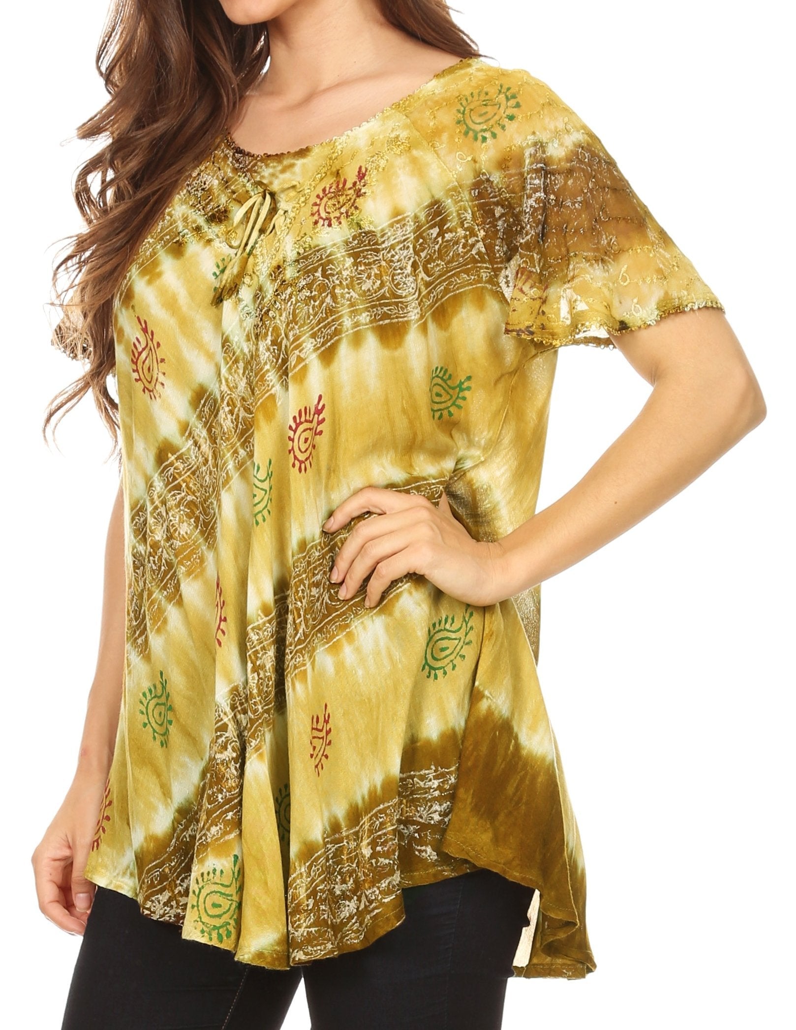 Woman wearing a yellow tie-dye shirt with intricate patterns on a white background