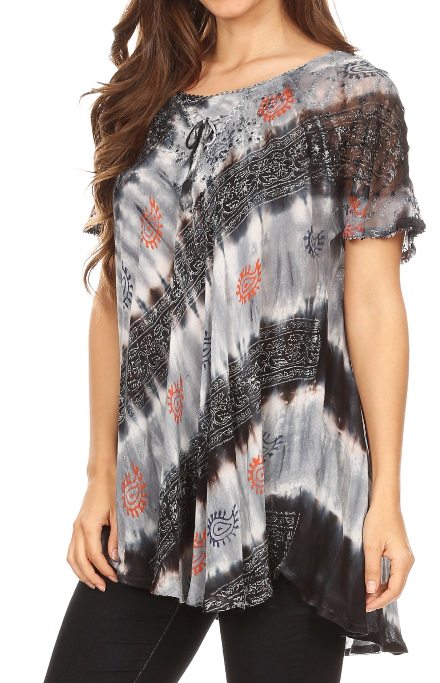 Woman wearing a patterned blouse with black, gray, and orange design on a white background