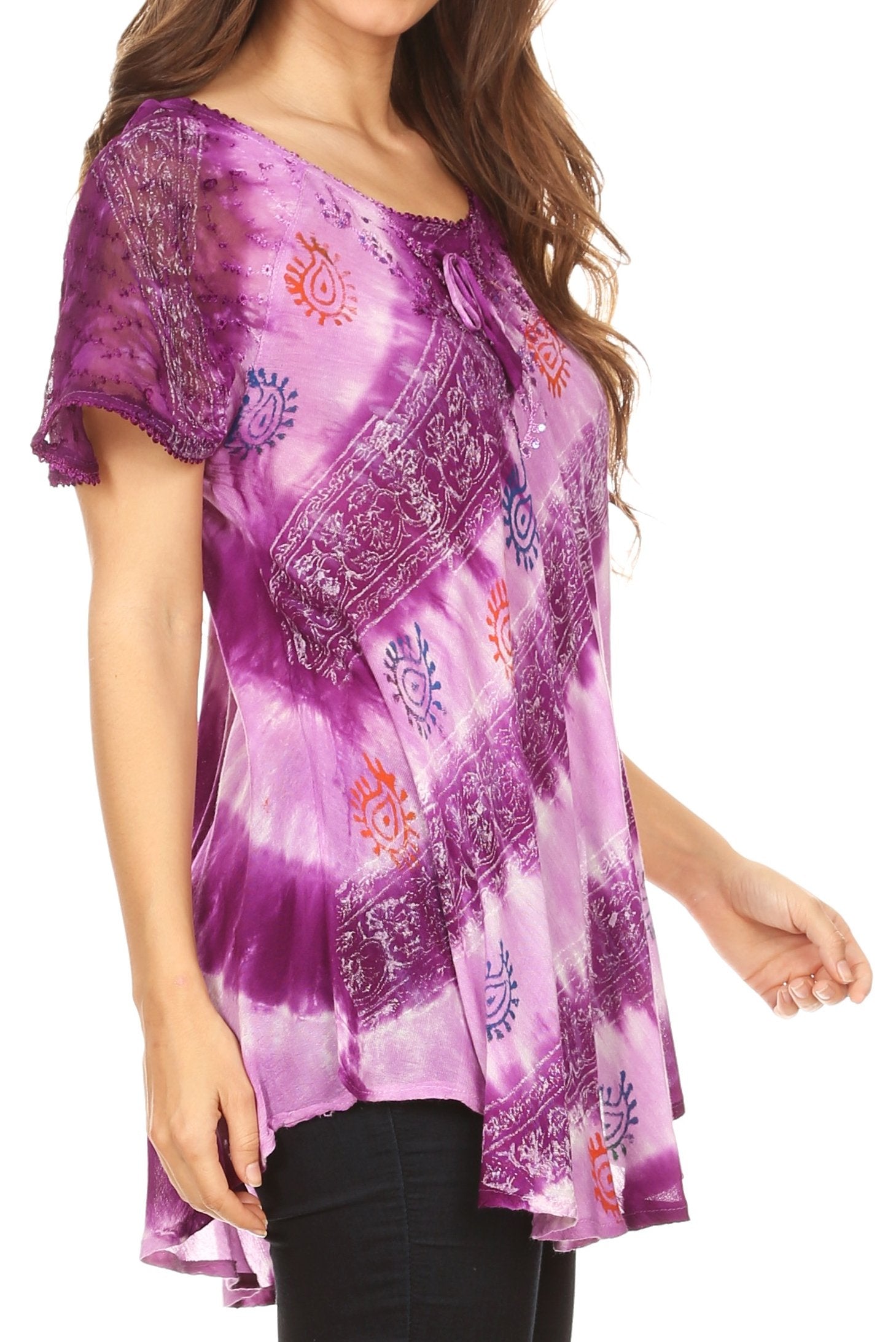 Woman wearing a purple tie-dye blouse with patterns on a white background