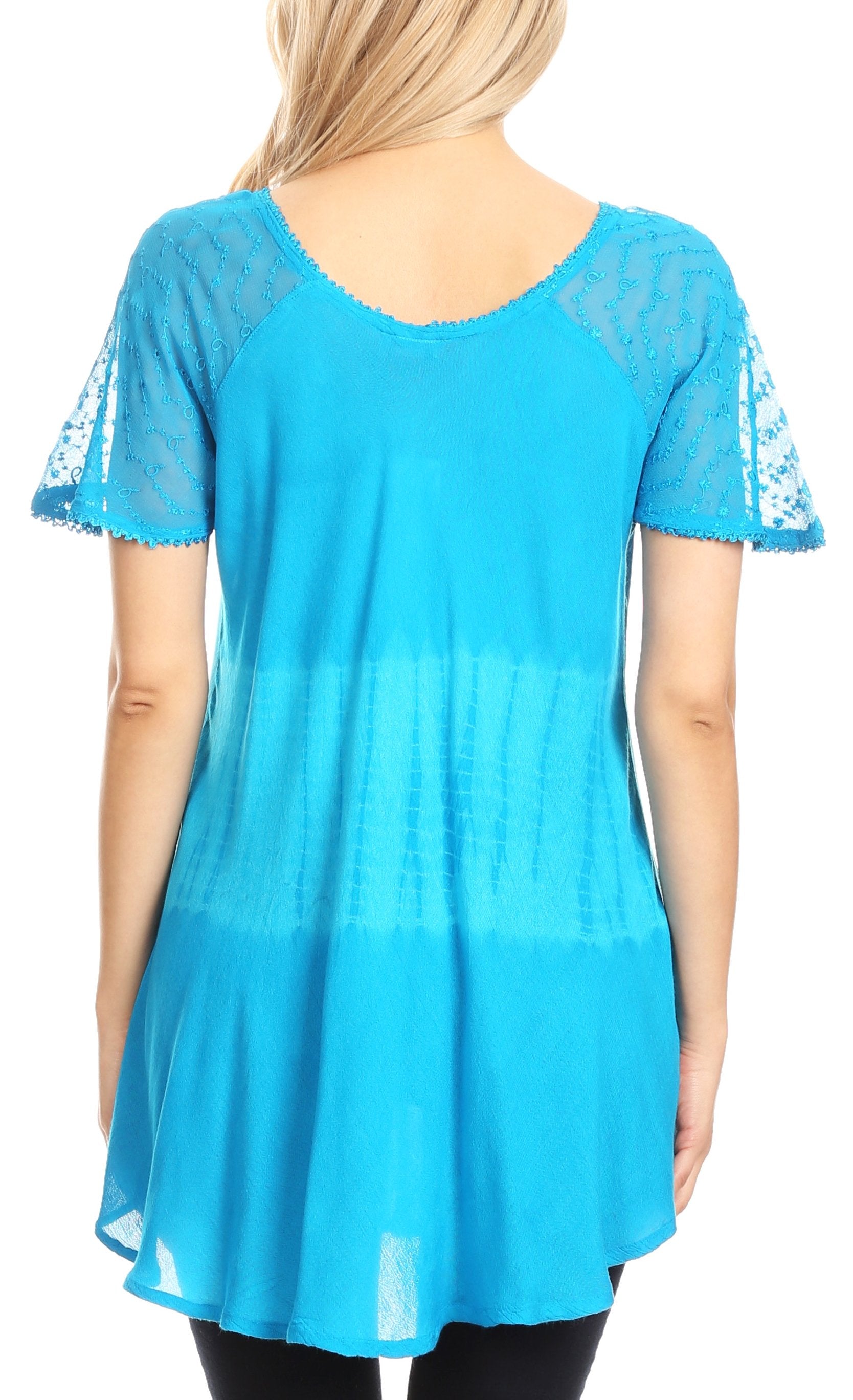Blue lace-trimmed top worn by a person on a white background
