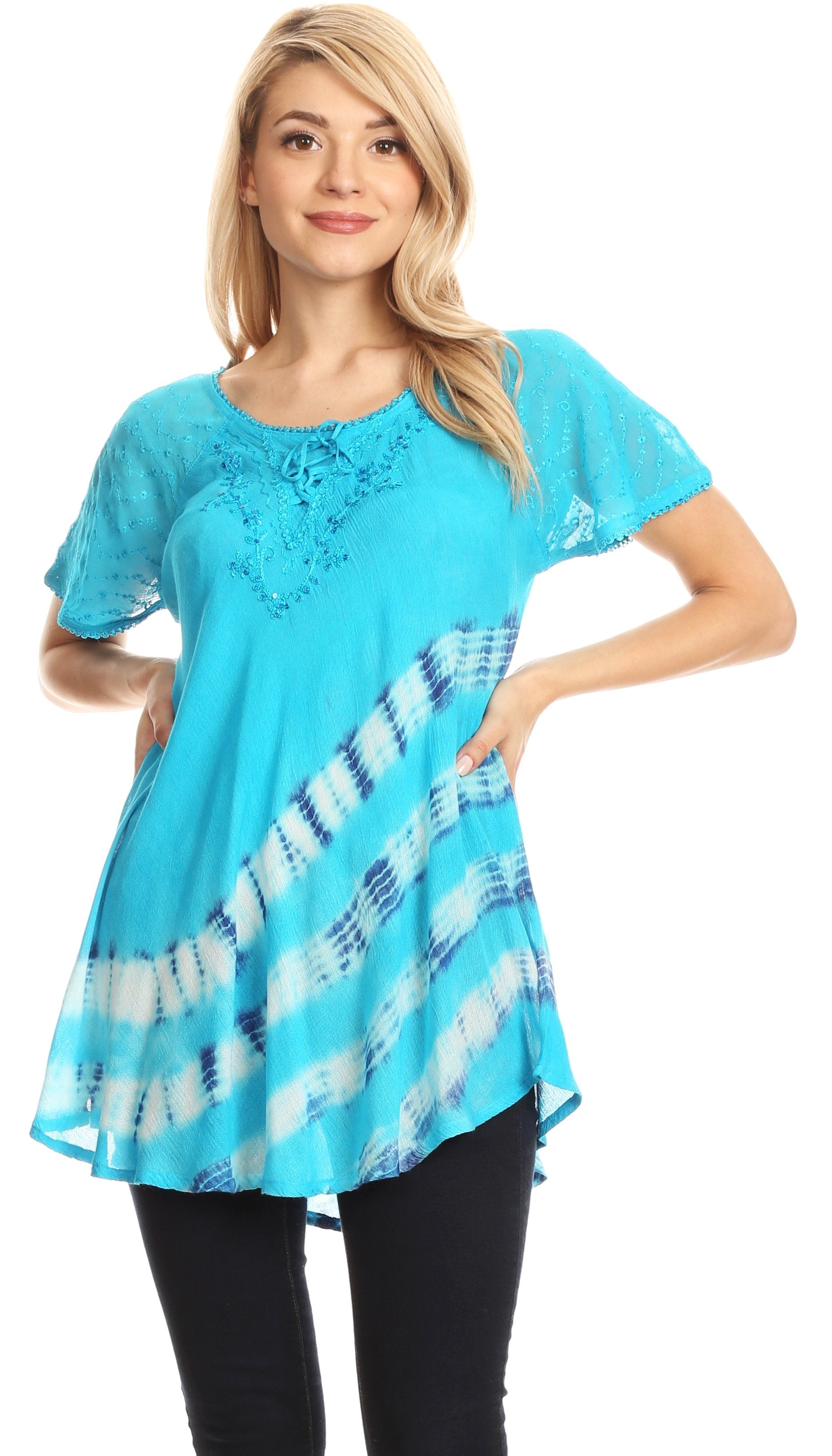 Woman wearing a blue lace top with tie-dye design on a white background
