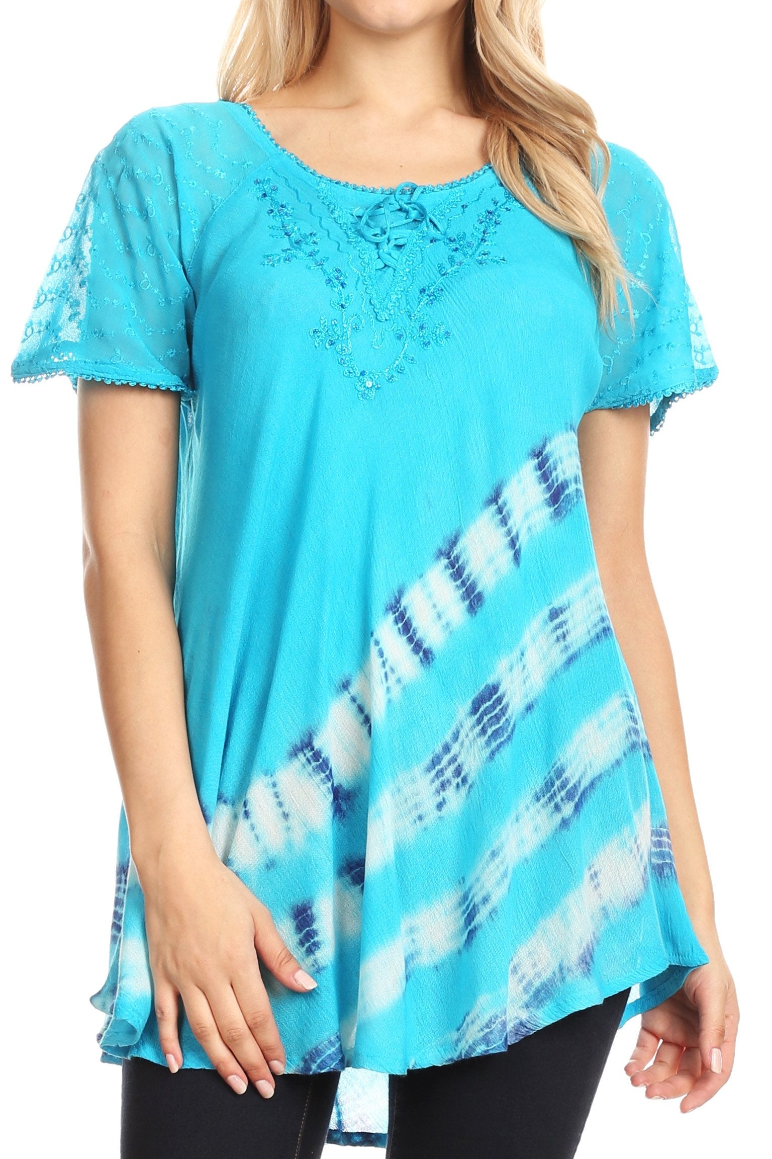 Woman wearing a turquoise tunic with lace details and tie-dye pattern.