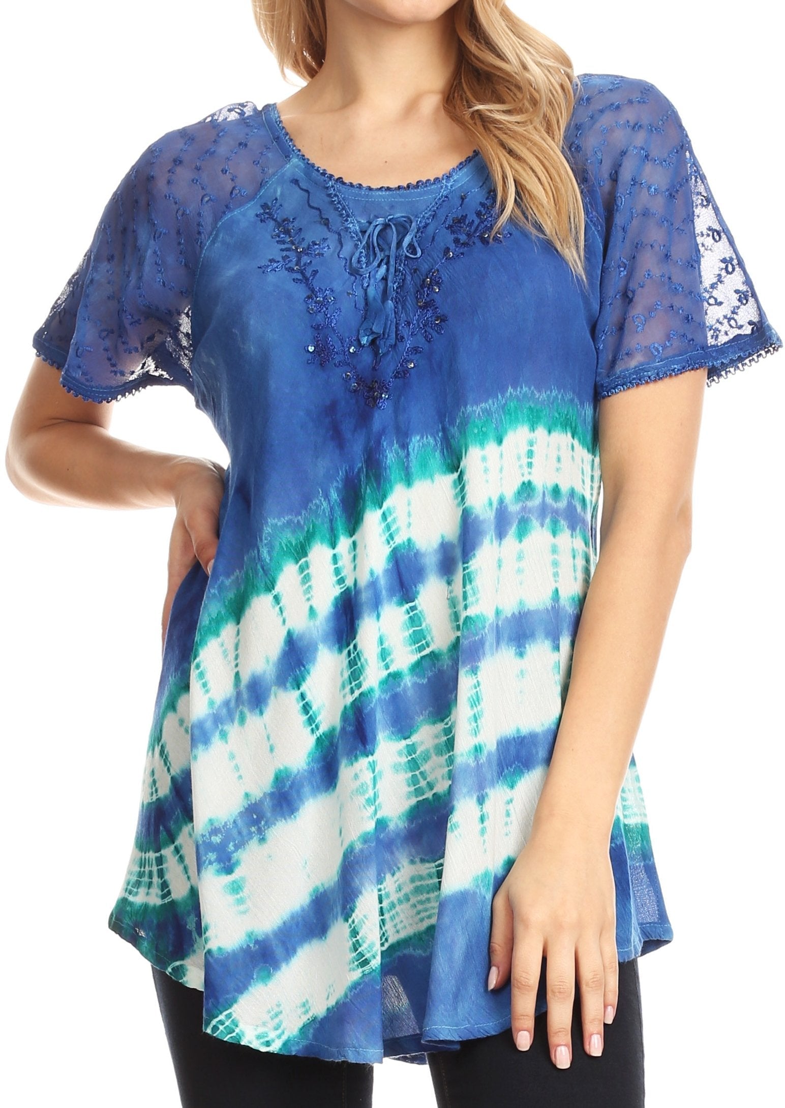 Woman wearing a blue and green tie-dye top with lace sleeves on a white background