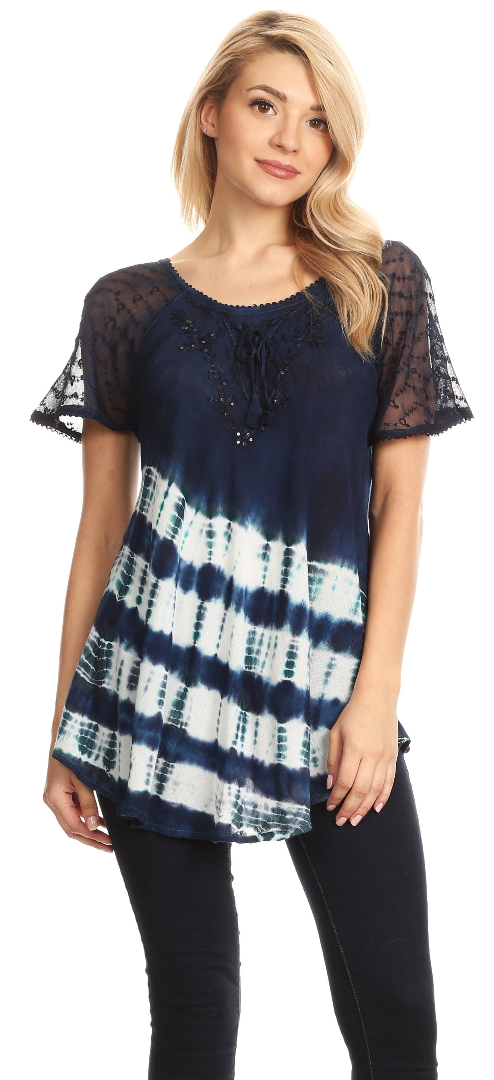 Woman wearing a navy tie-dye top with sheer sleeves on a white background