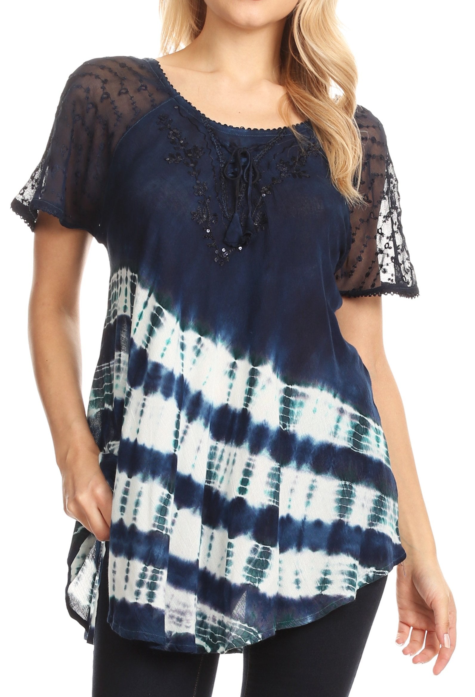 Woman wearing a navy blue and white tie-dye top with sheer sleeves.