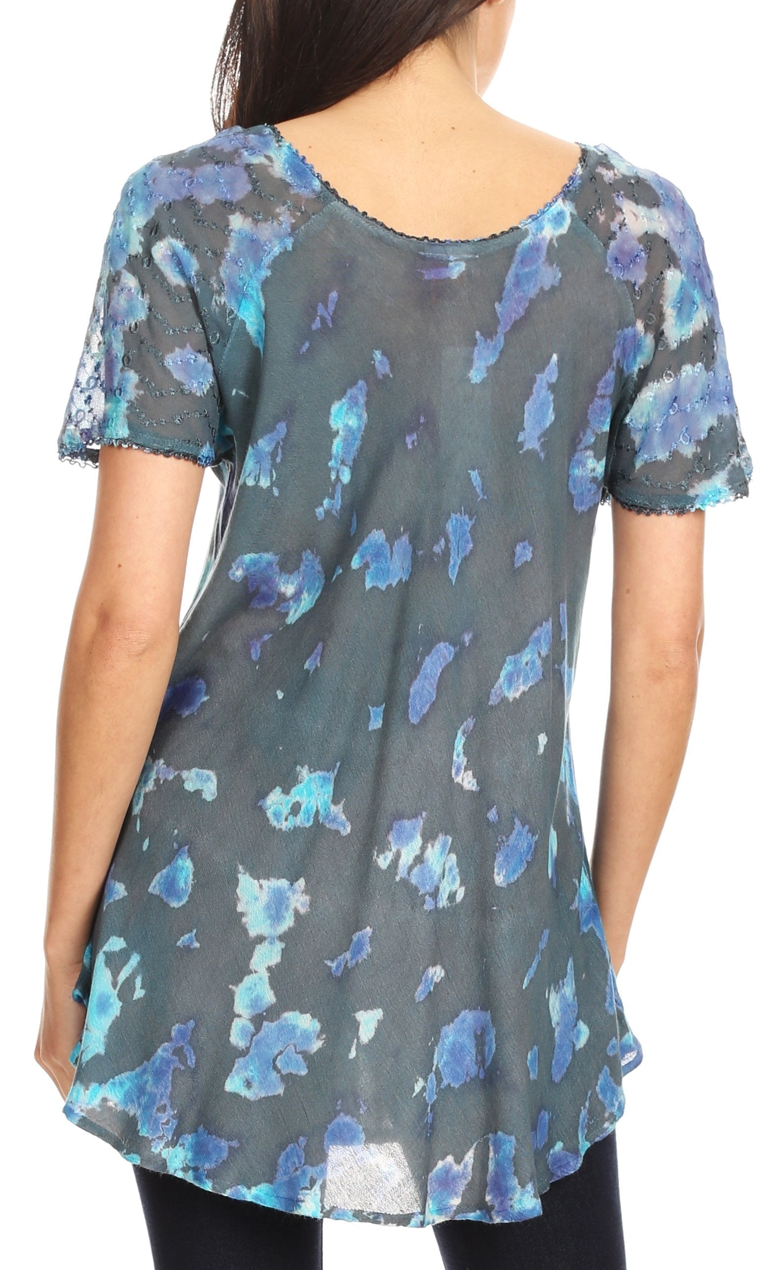 Woman wearing a short-sleeve top with blue floral pattern on a gray background