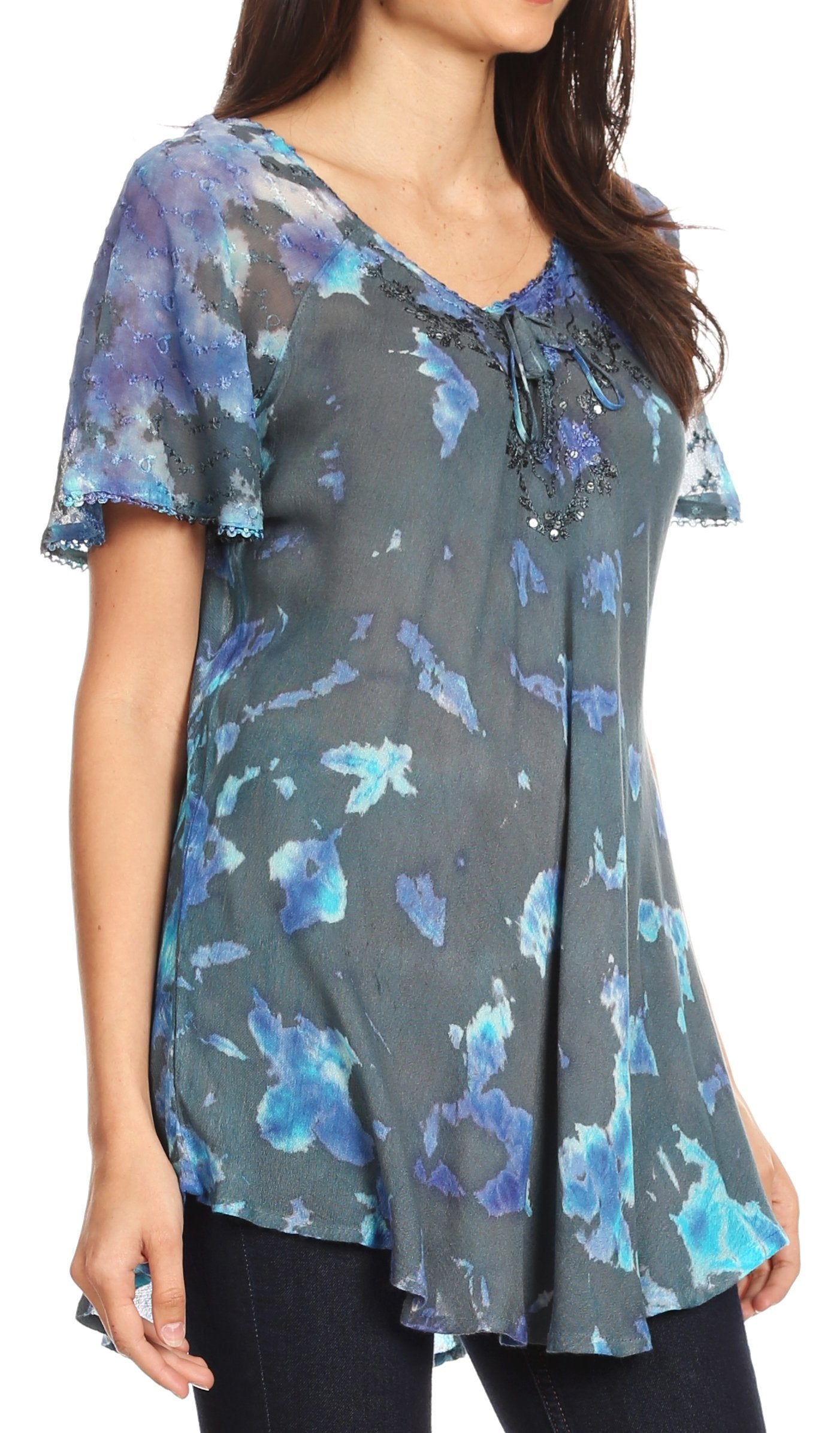 Woman wearing a gray floral blouse with blue flowers