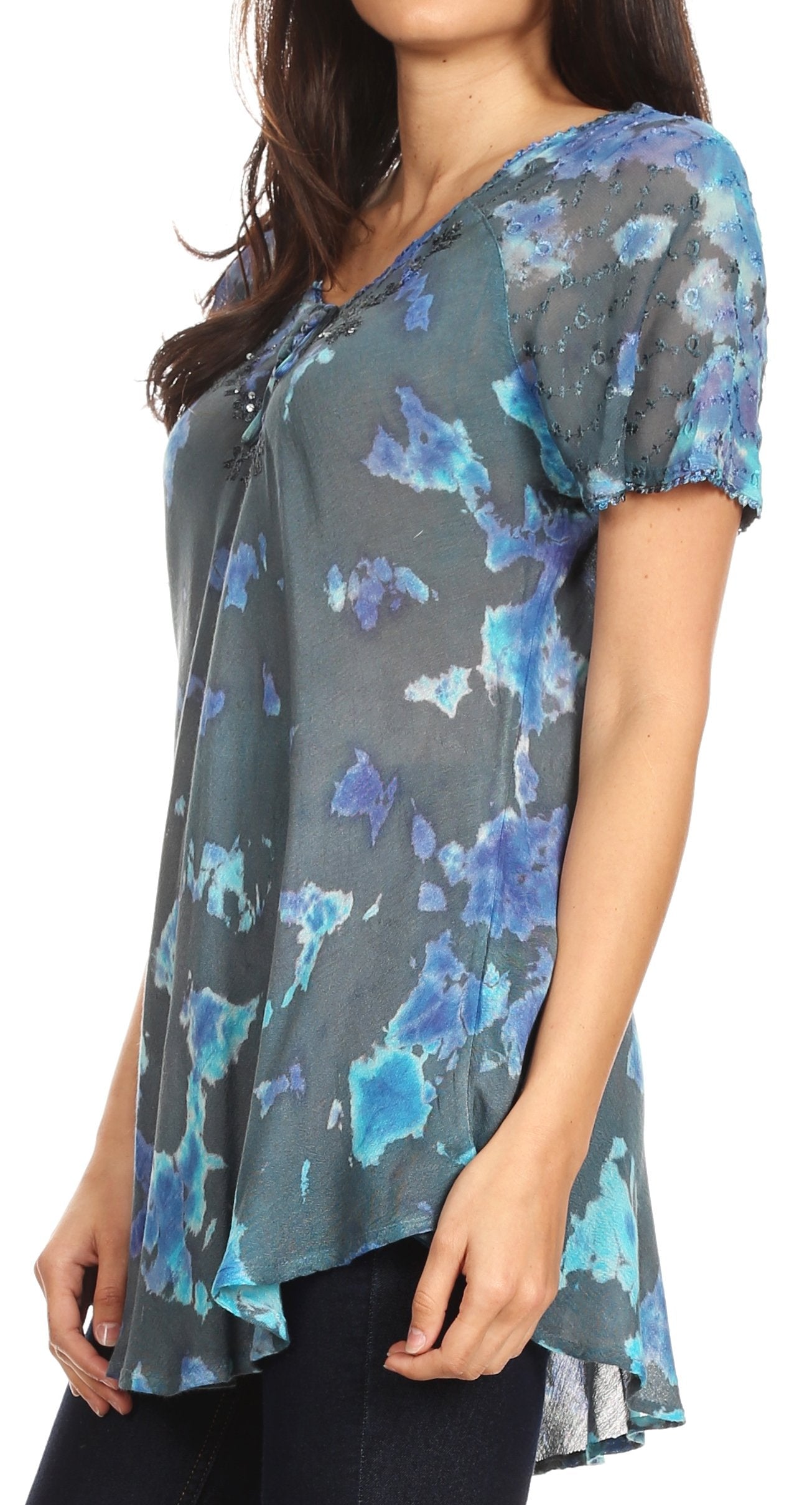 Woman wearing a blue and gray patterned top with a white background