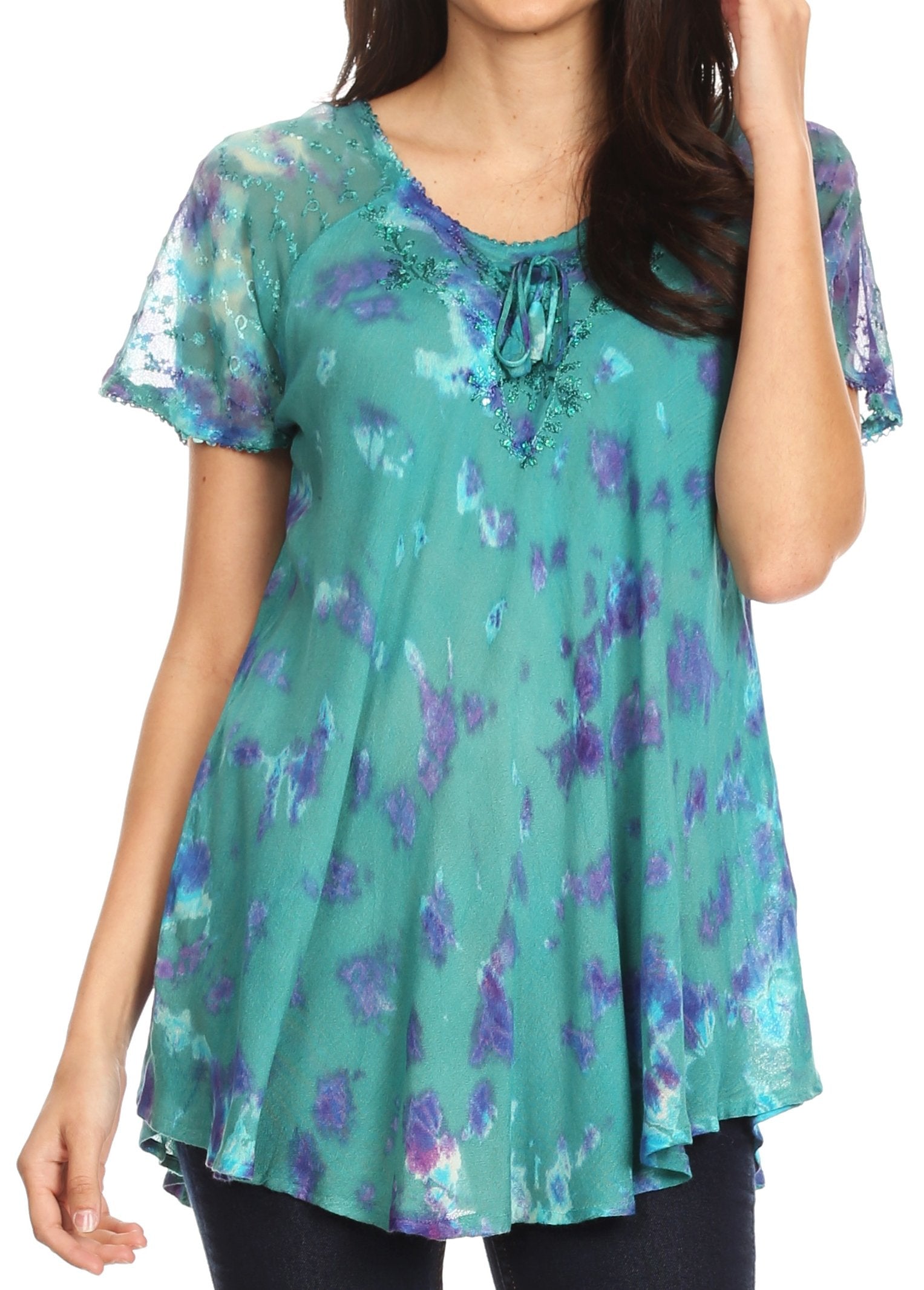 Woman wearing a teal floral print top on a white background