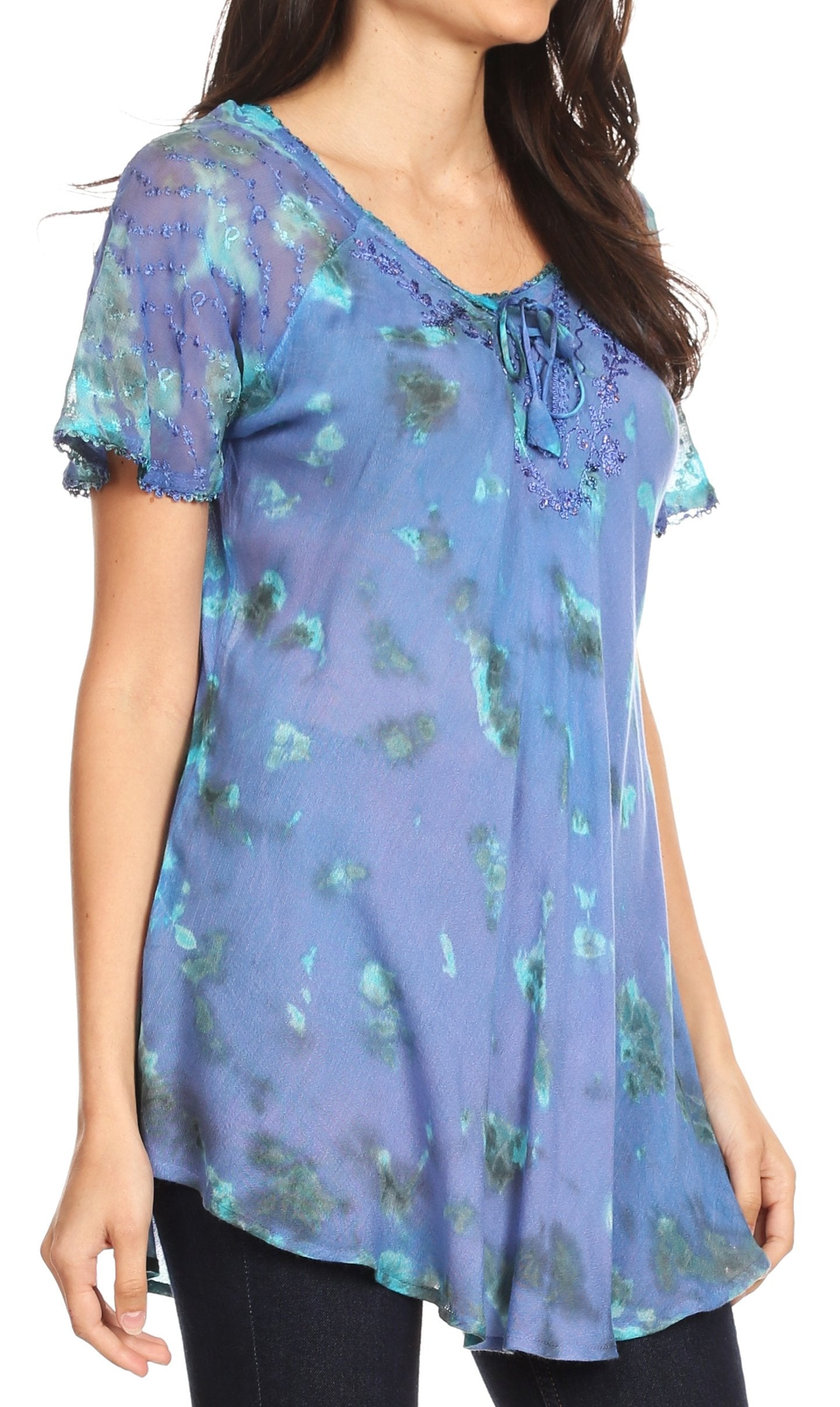 Woman wearing a blue floral blouse with a tie neckline.