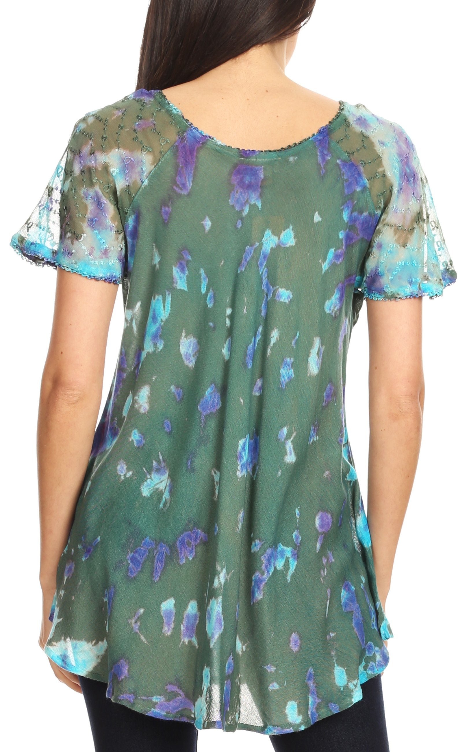 Woman wearing a green floral blouse with sheer sleeves on a white background