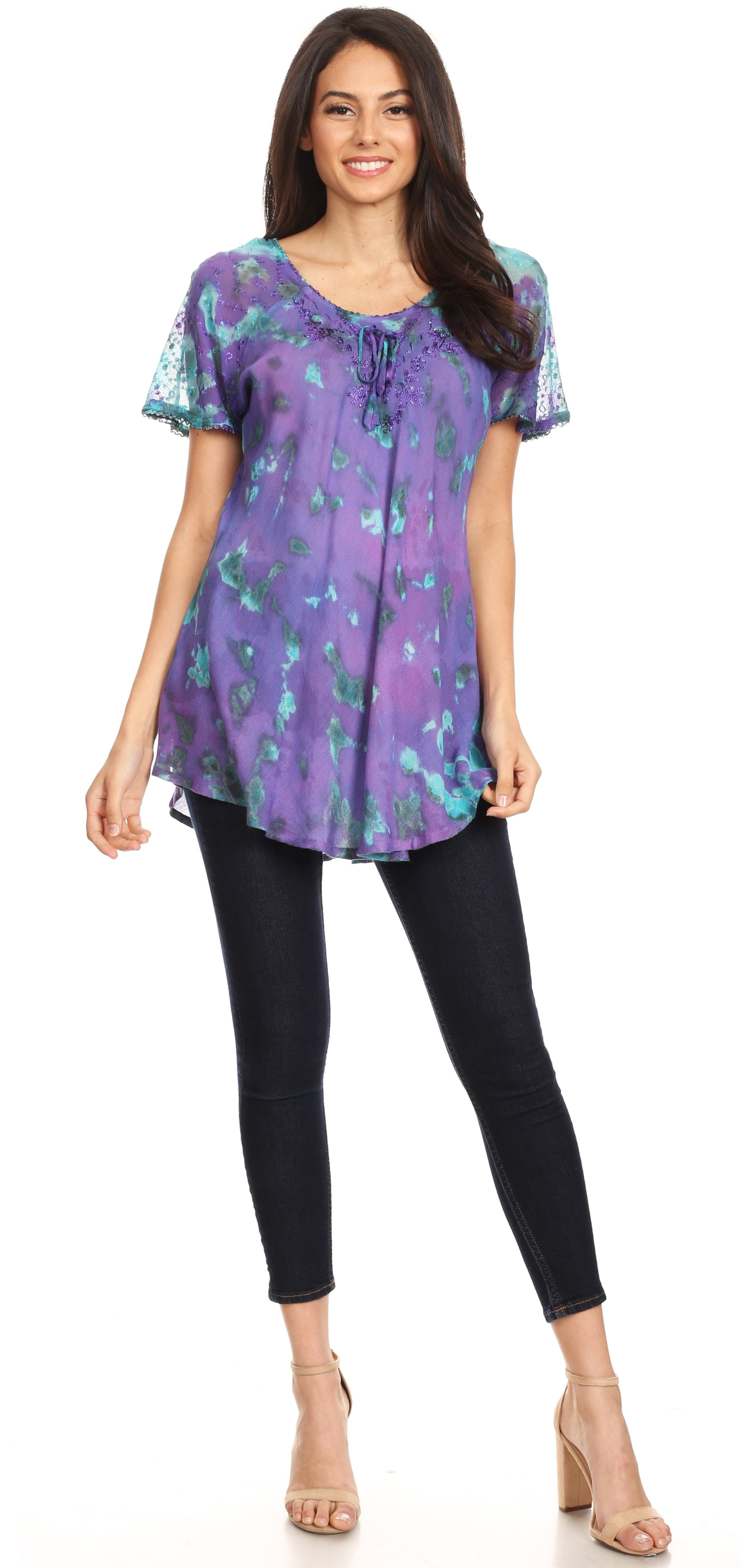 Woman wearing a purple floral blouse and black pants on a white background