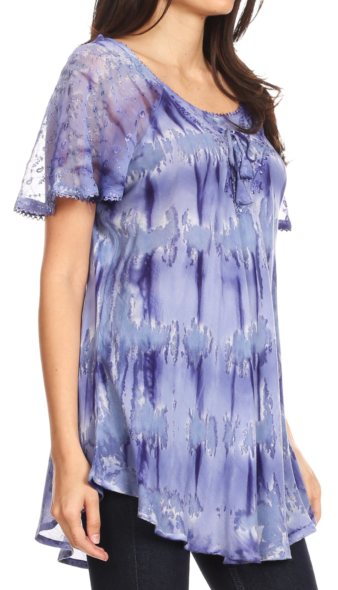 Woman wearing a blue tie-dye top with lace sleeves on a white background
