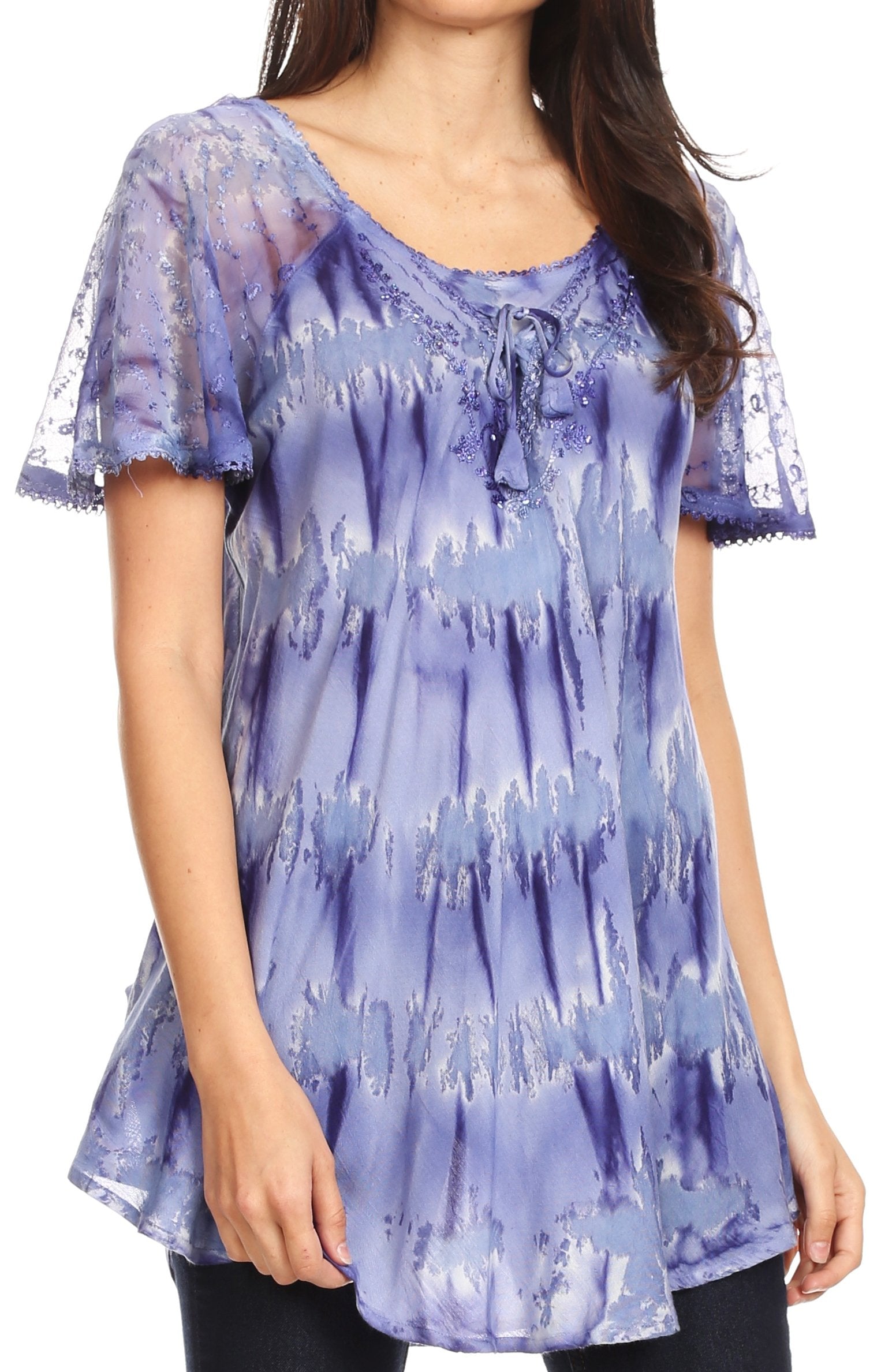 Woman wearing a purple tie-dye blouse with sheer sleeves on a white background