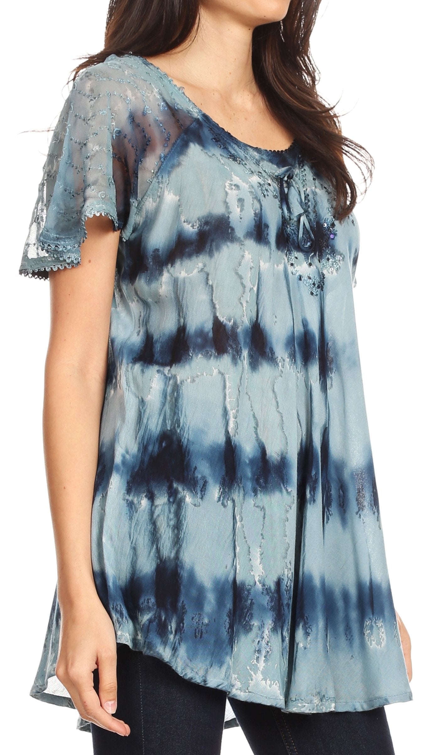 Woman wearing a blue tie-dye top with lace sleeves on a white background