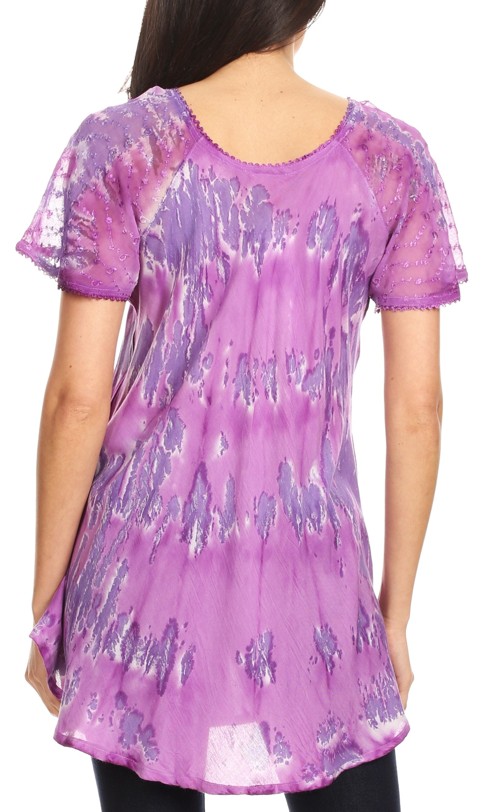 Purple floral patterned tunic worn by a person on a white background