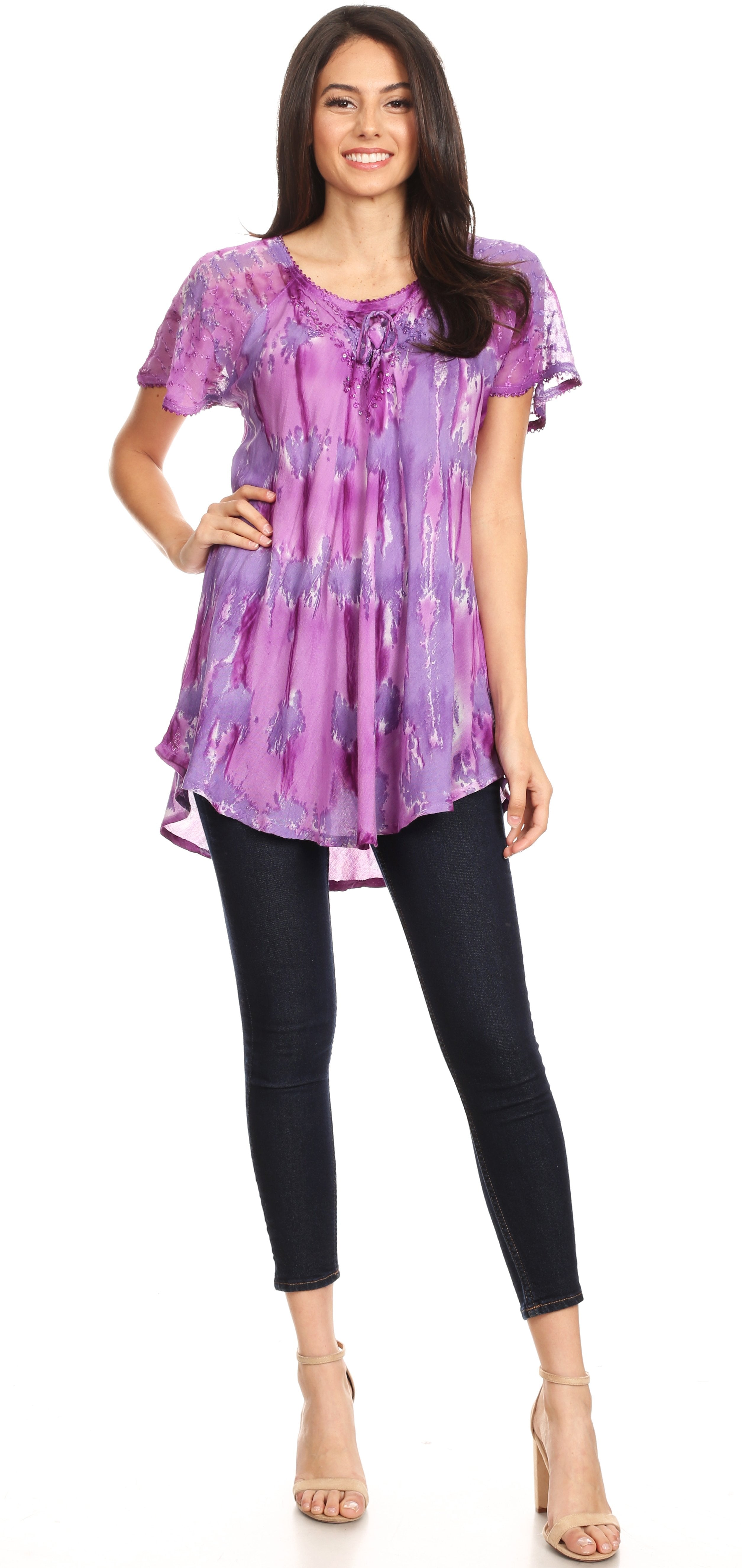 Woman wearing a purple tie-dye top and black pants on a white background