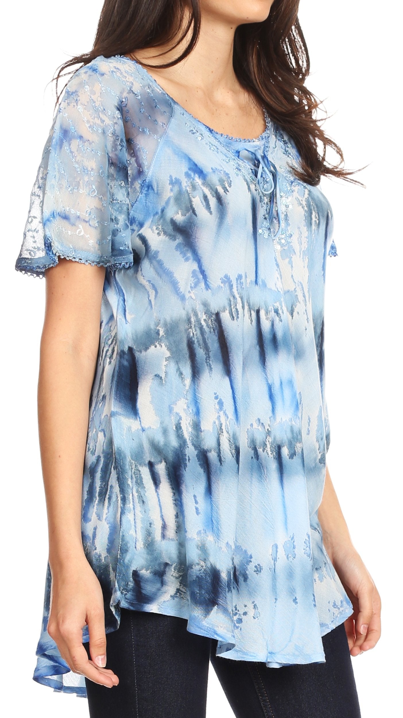 Woman wearing a blue tie-dye blouse with a blurred background