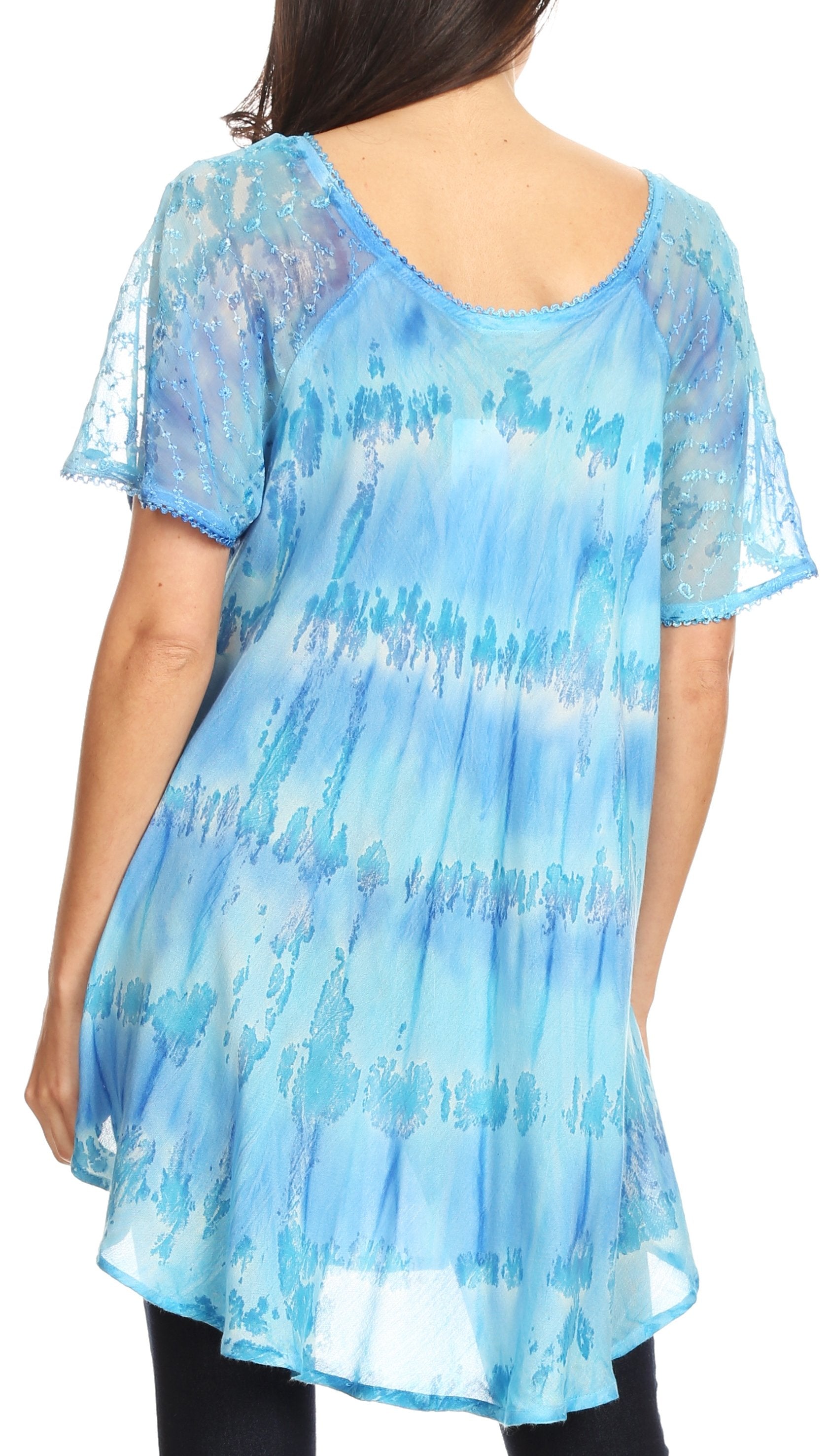 Blue patterned tunic worn by a person on a white background