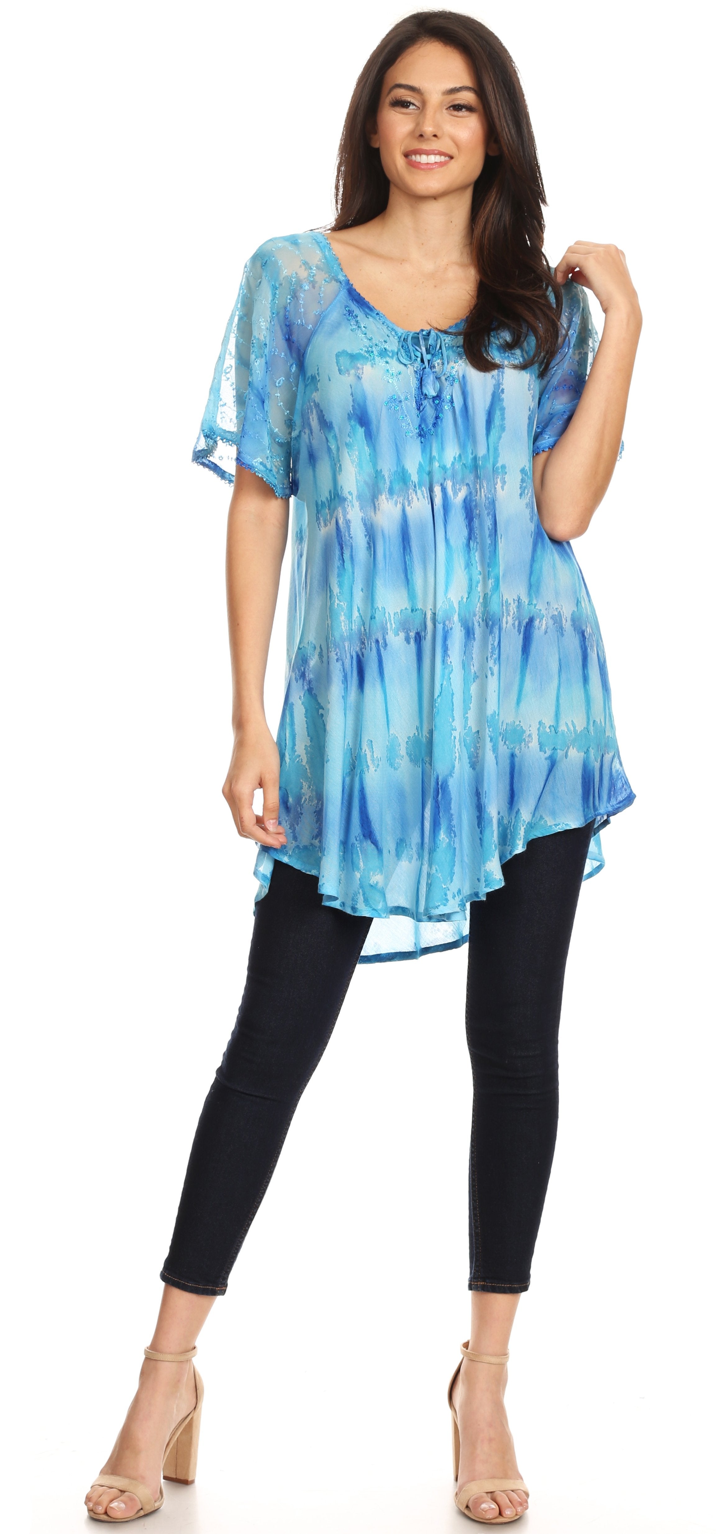 Woman wearing a blue tie-dye top and black leggings on a white background