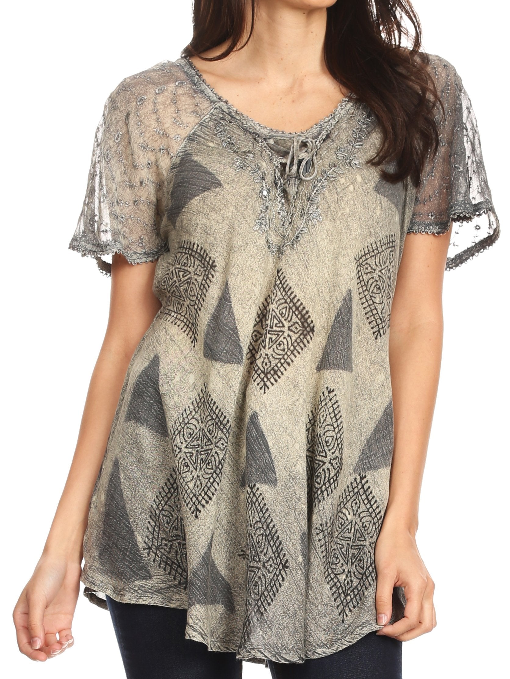 Woman wearing a patterned blouse with lace sleeves on a white background