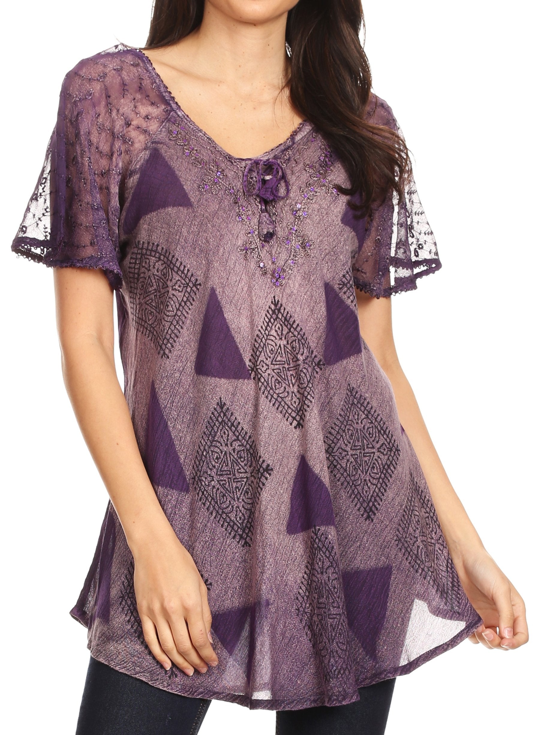 Purple patterned blouse with lace sleeves worn by a model on a white background