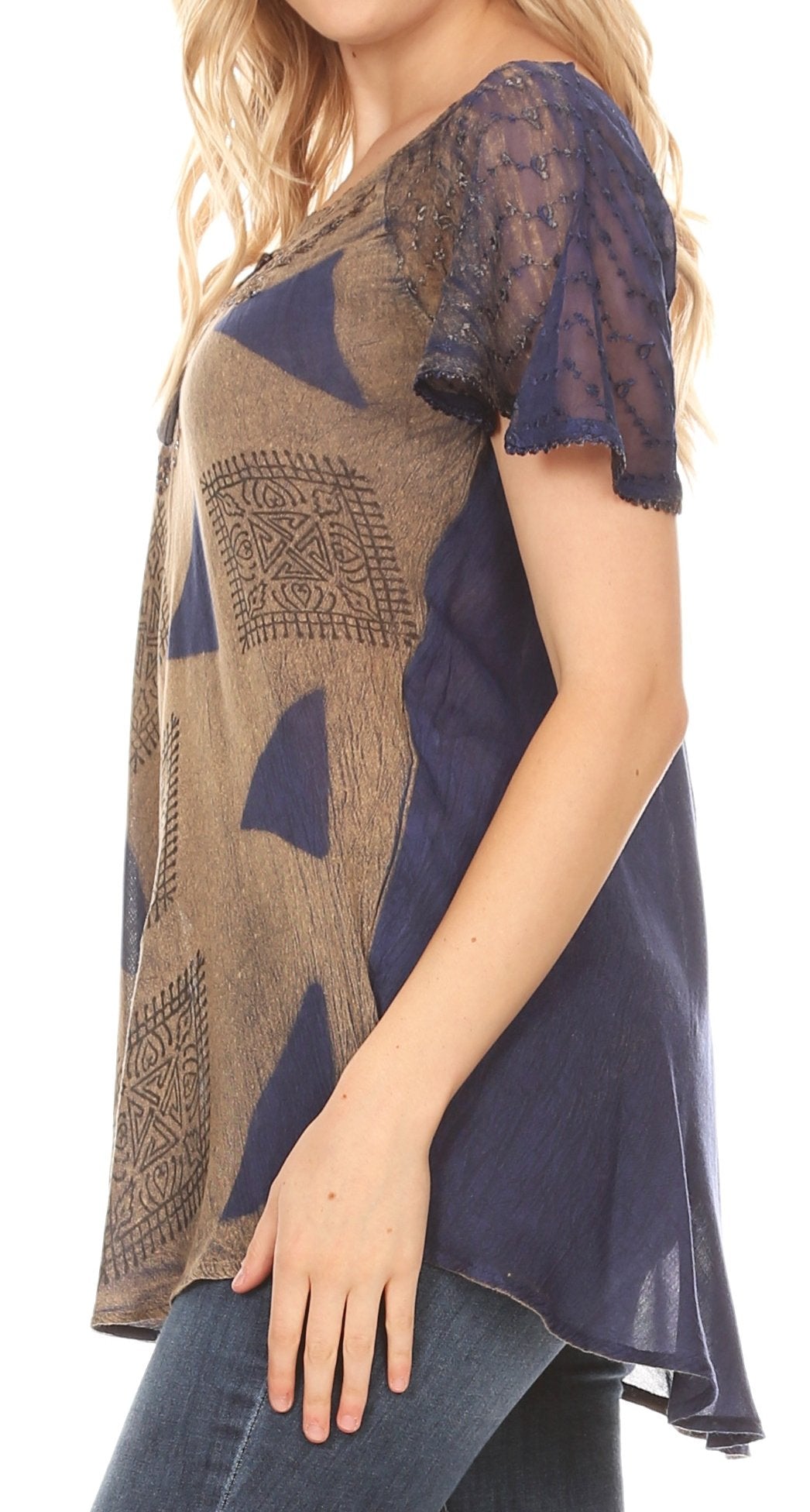 Woman wearing a patterned top with a high-low hem design.