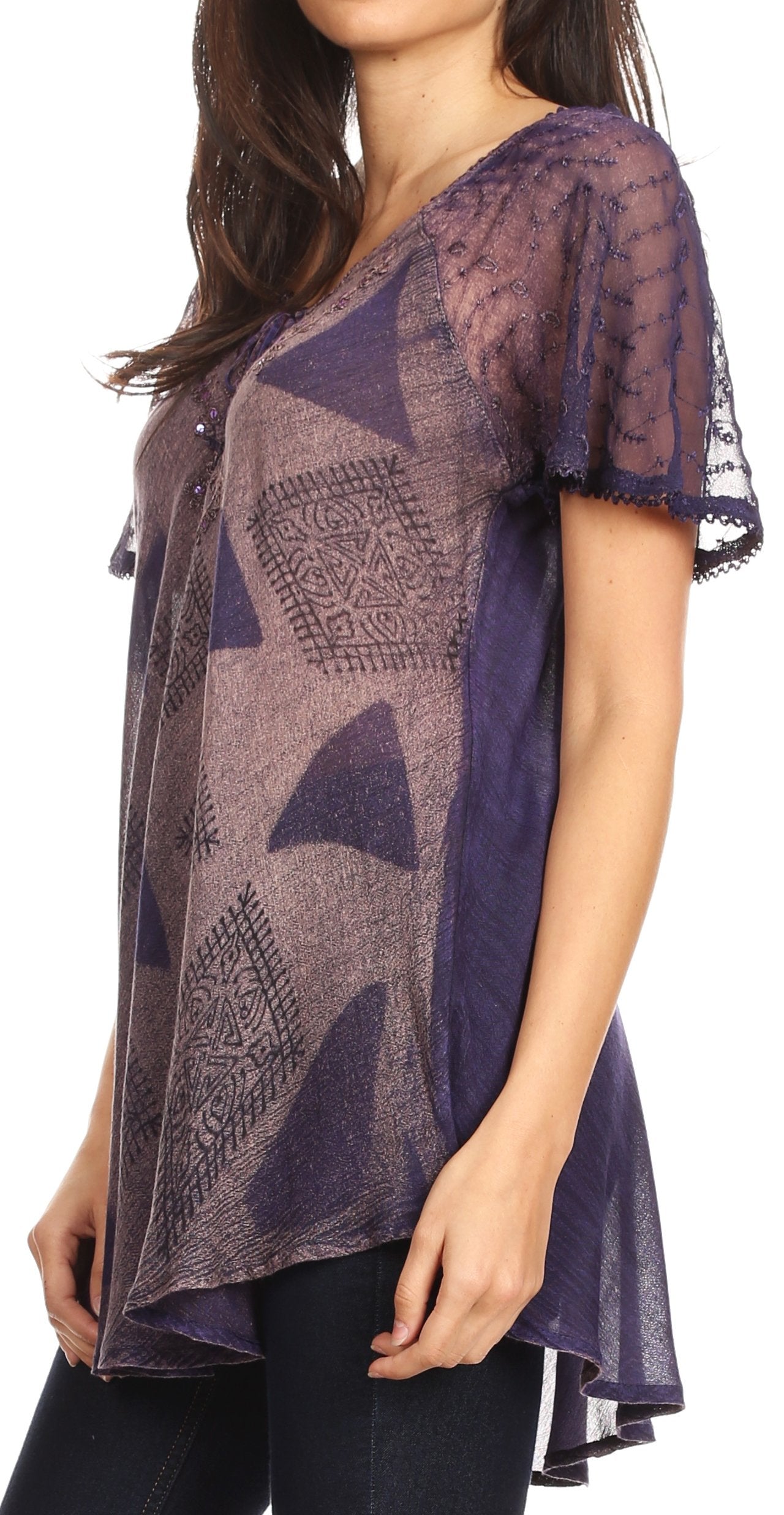 Woman wearing a sheer purple top with geometric patterns on a white background