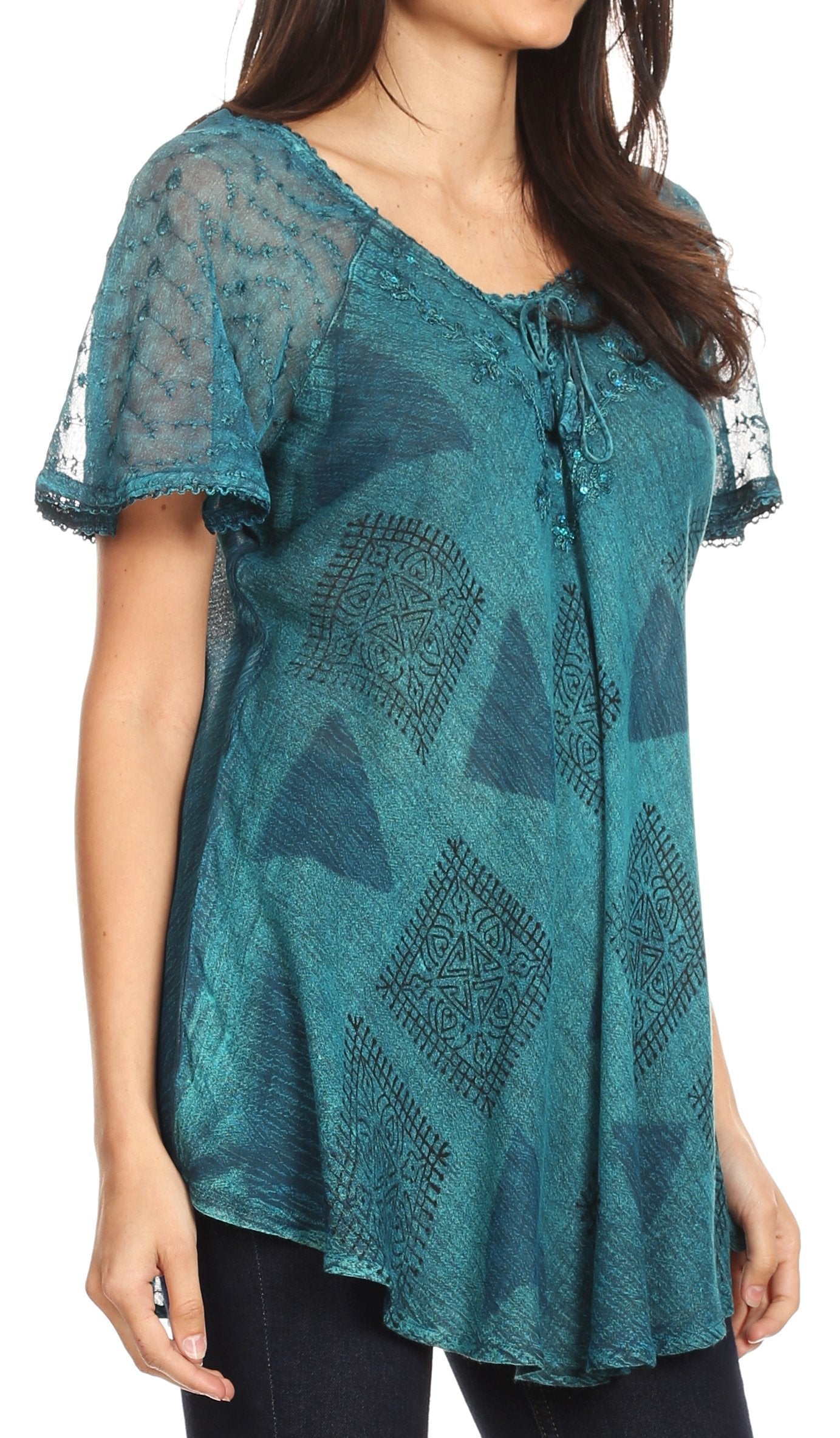 Teal patterned top worn by a model on a white background