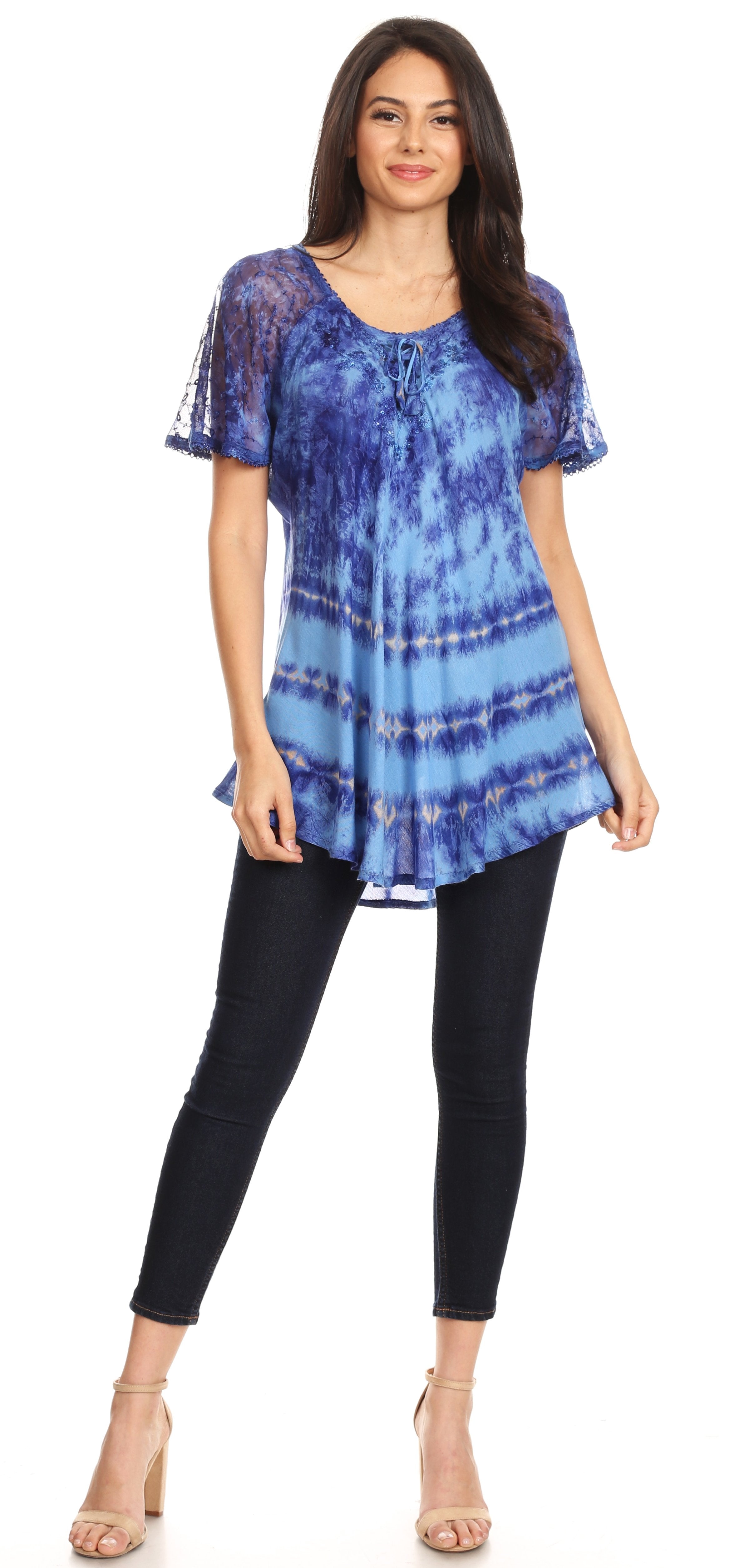 Woman wearing a blue tie-dye top and black leggings on a white background