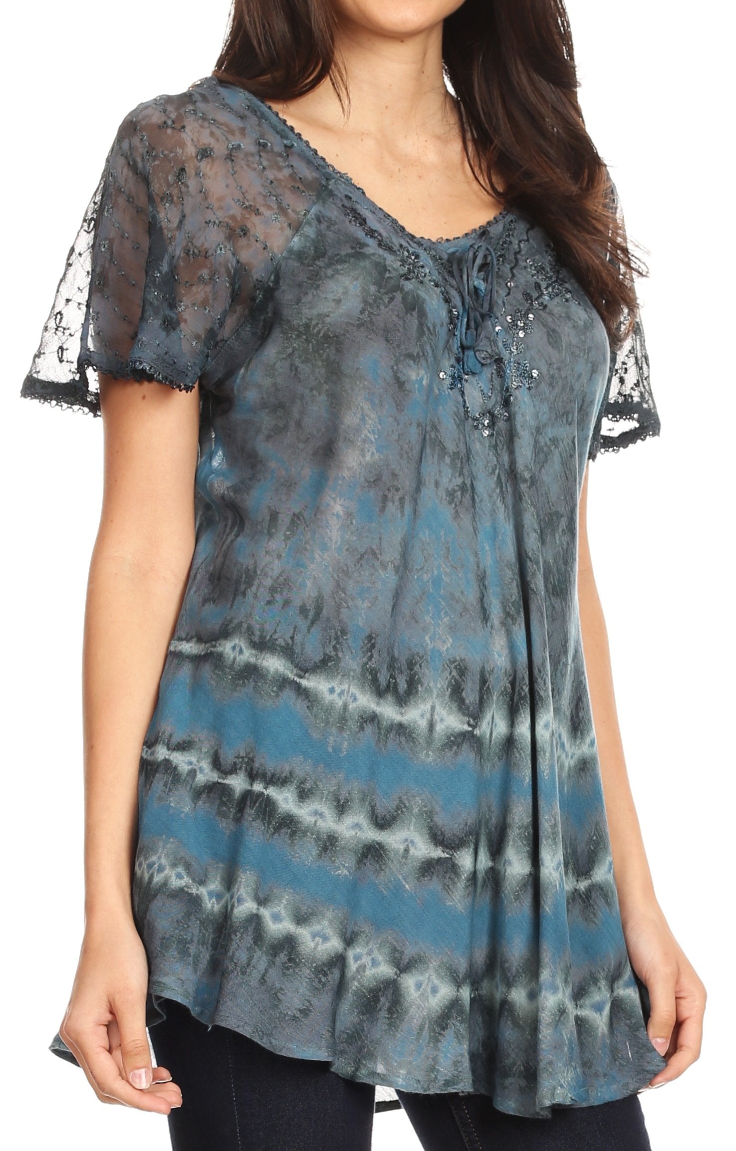 Woman wearing a blue and gray patterned blouse with sheer sleeves on a white background